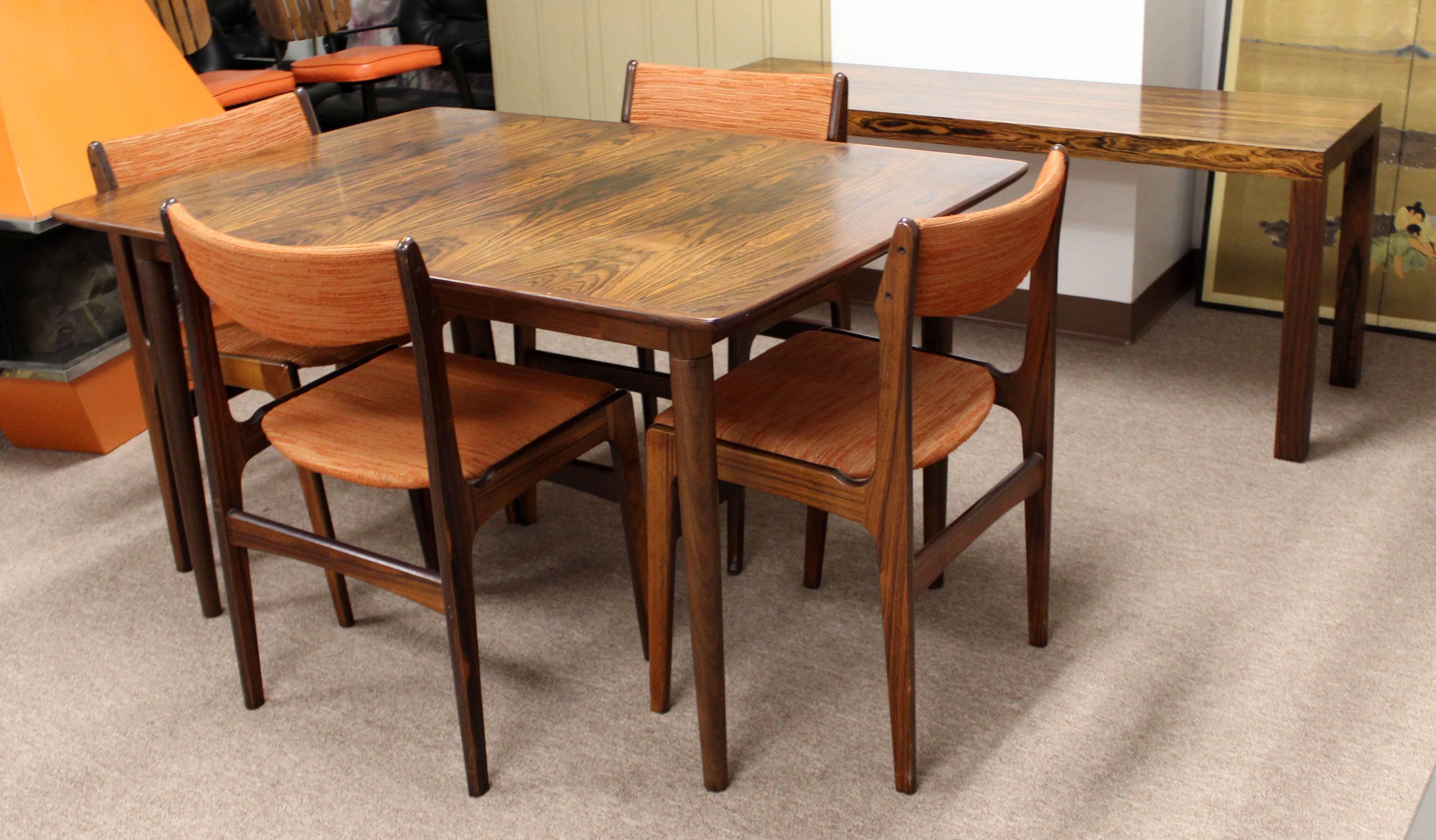 For your consideration is an incredible, rich rosewood dining set, including an expandable table with two leaves and four side chairs. Leaves store in the table. Made in Denmark. In excellent condition. Matching console table available in separate