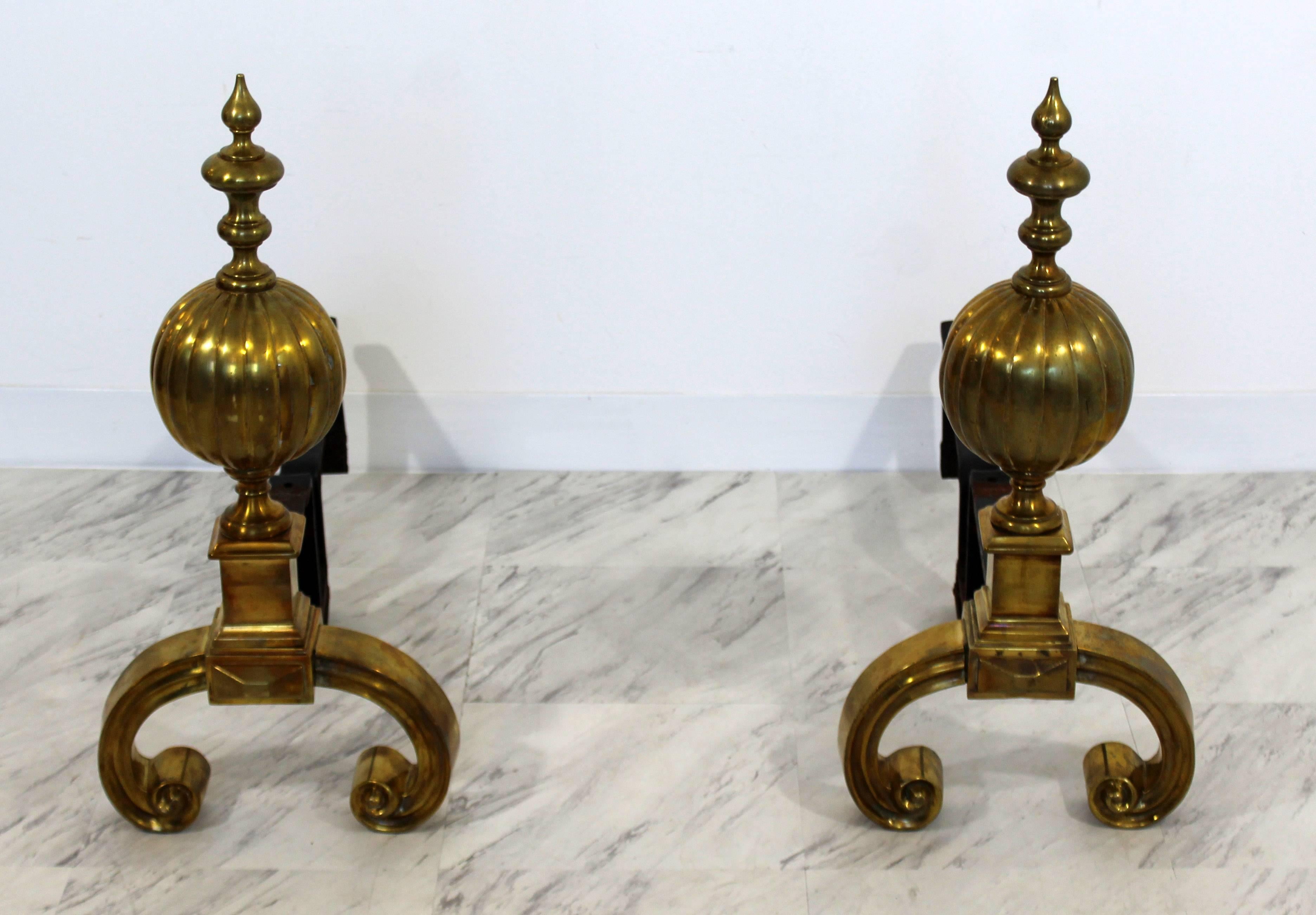 For your consideration is an incredible pair of solid brass and iron andirons, with a gorgeous decorative shape to them. In excellent condition. The dimensions are 12