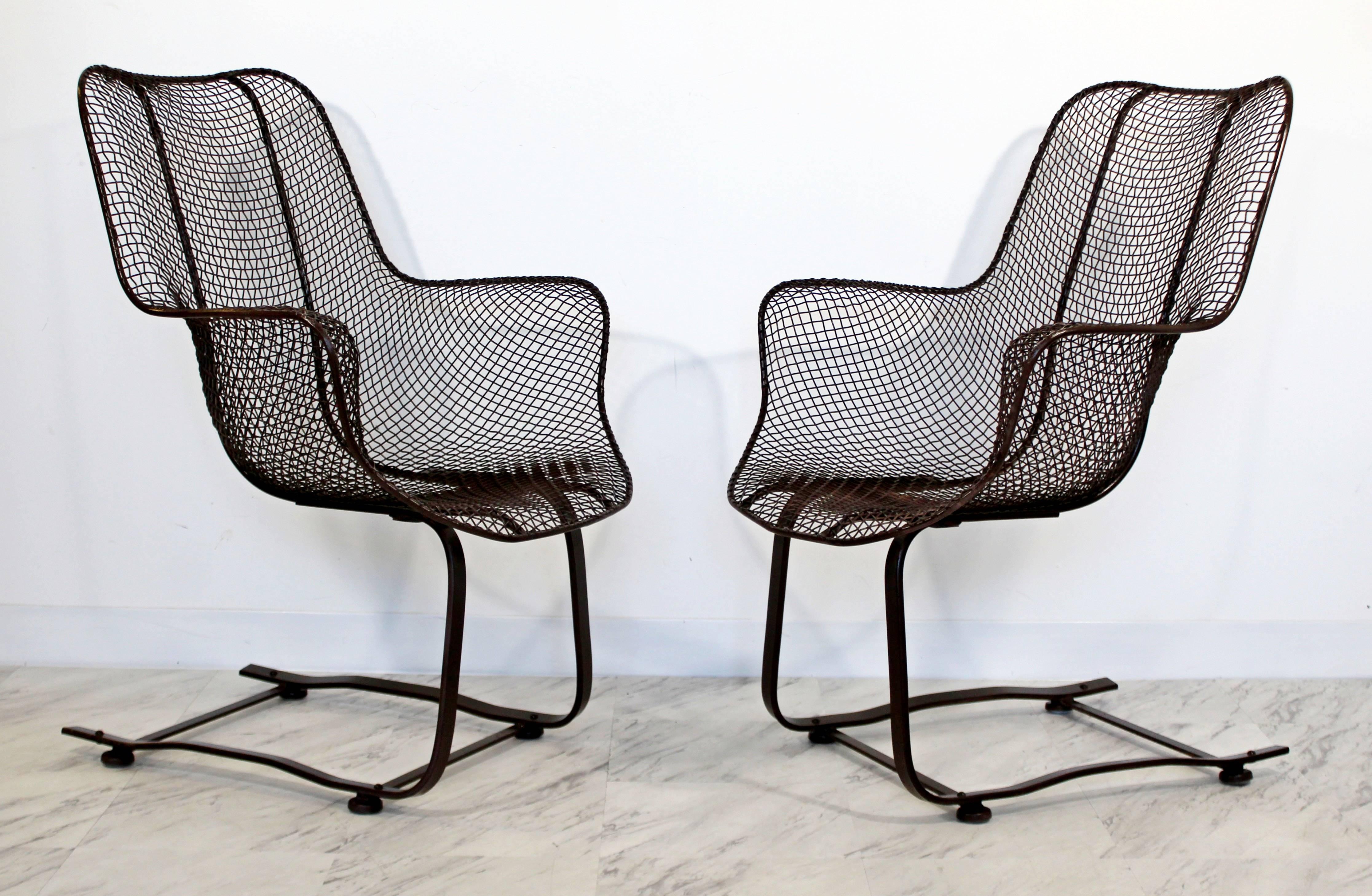 For your consideration is a brilliant pair of brown, rocker lounge chairs, by Woodard Sculptura, circa the 1970s. In excellent condition. The dimensions are 27" Sq x 35" H x 14" S.H.