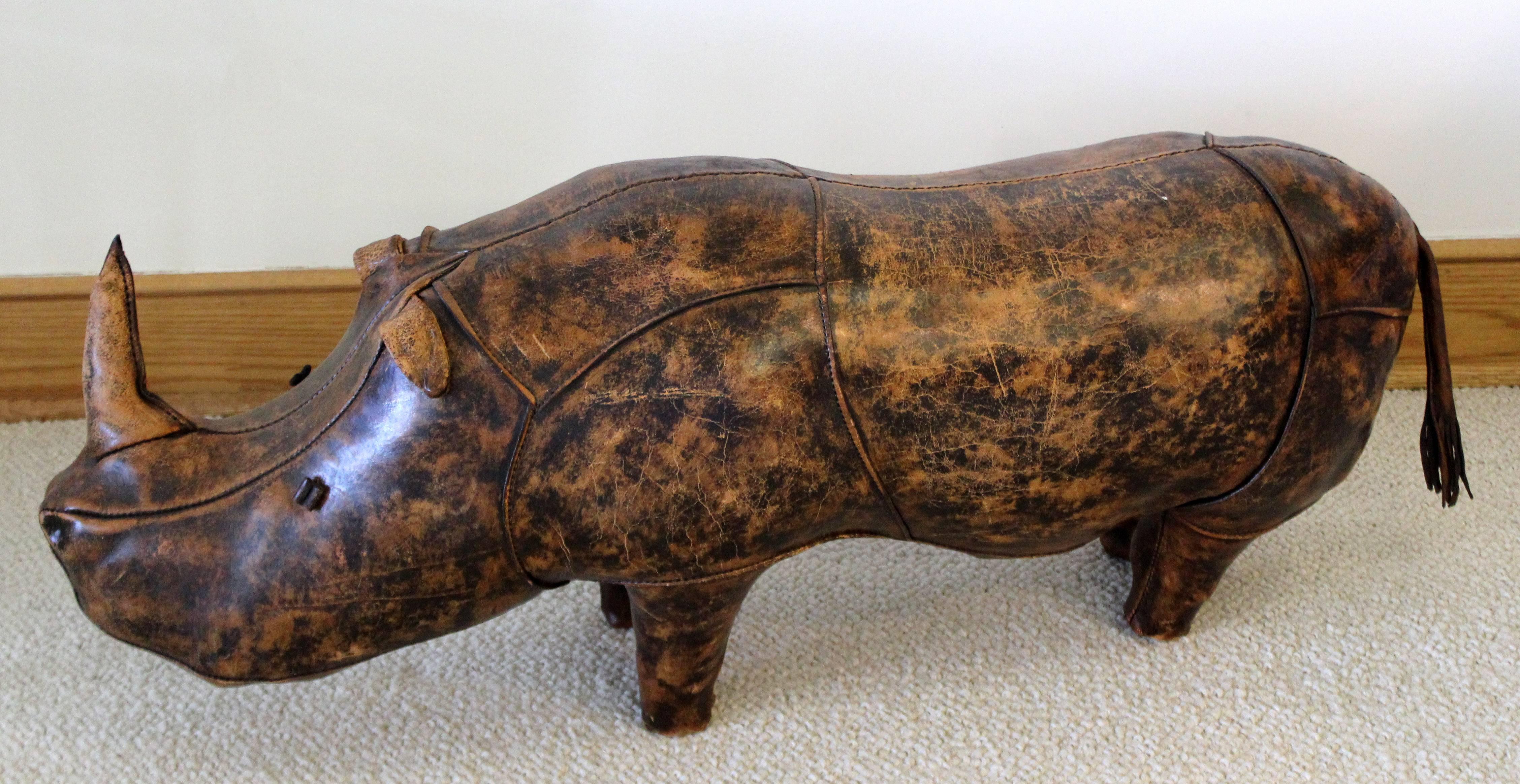 For your consideration is a stuffed, hand-stitched leather footstool, in the whimsical shape of a rhino, from a 1960s series that Abercrombie & Fitch had commissioned from the British company Omersa. In excellent condition, with a gorgeous patina.
