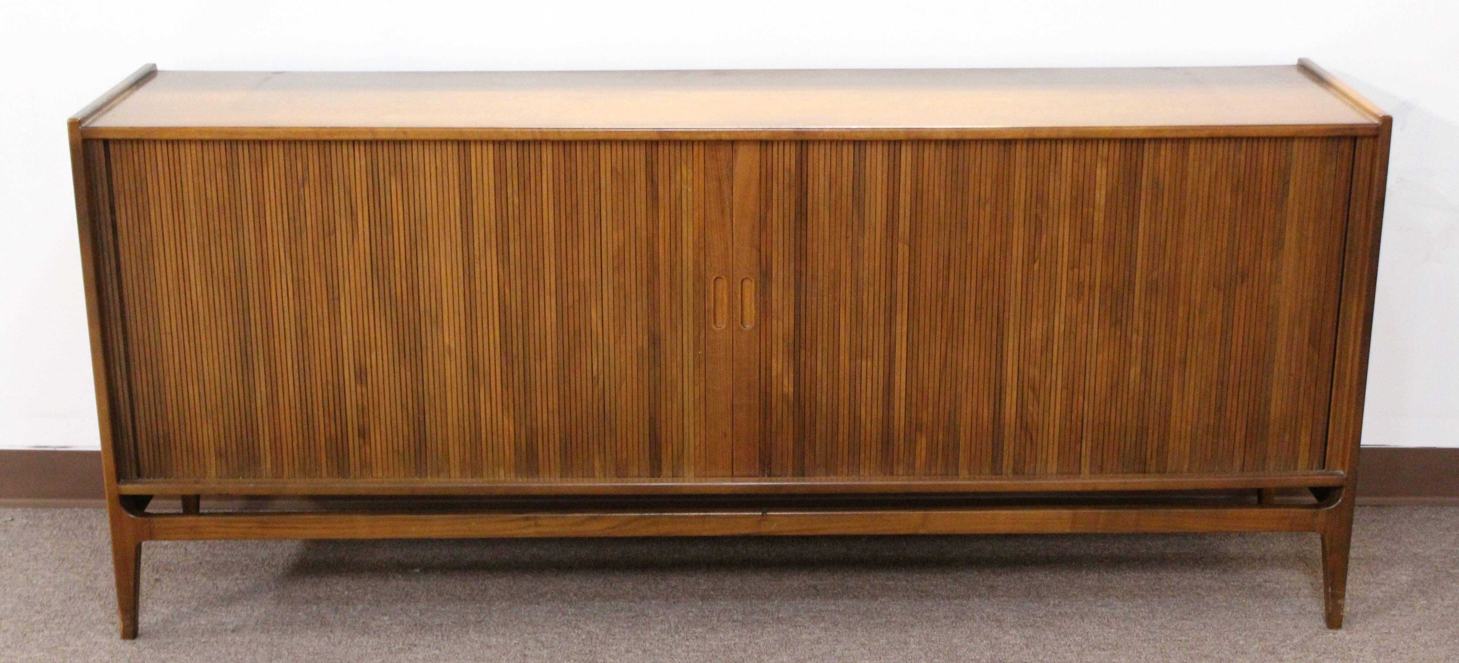 For your consideration is a stunning walnut wood sideboard credenza by Richard Thompson for Glenn of California. Has two tambour sliding doors, with compartment space and drawers. In very good vintage condition. The dimensions are 71