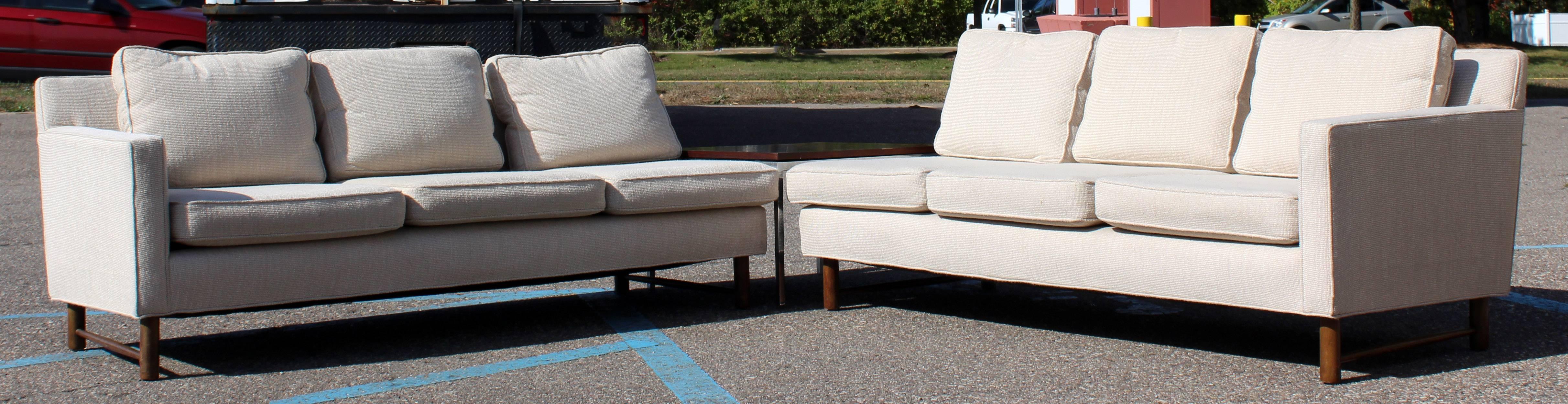 For your consideration is a fantastic, two-piece, sectional sofa, on a unique, wooden base, by Dunbar. In original nubby oatmeal wool blend fabric. In excellent condition. The dimensions of each piece are 70