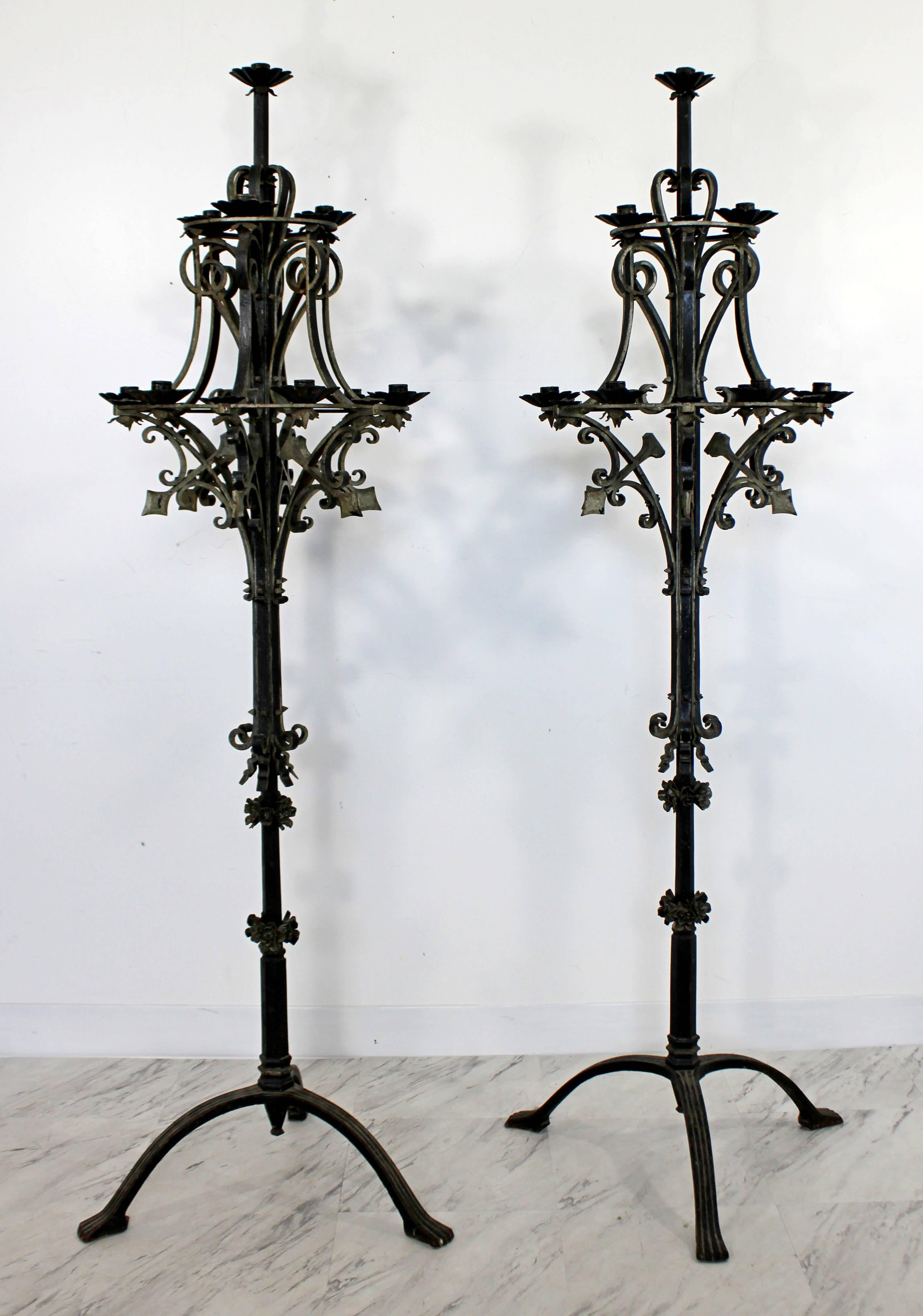 For your consideration is a thick and majestic pair of iron metal, standing candelabra, with floral designs. In great condition. The dimensions are 18