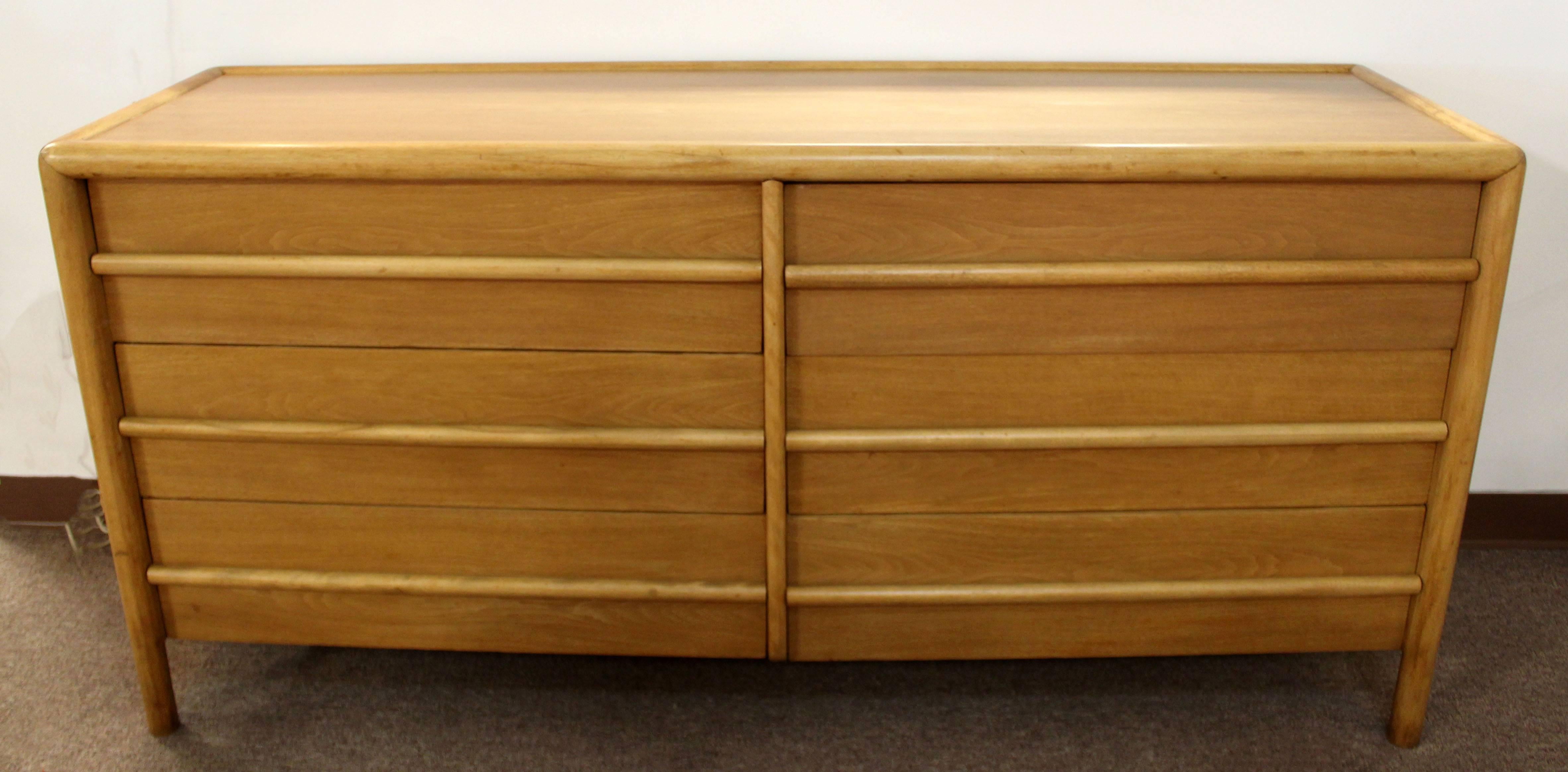 For your consideration is a rare, six-drawer with dividers honey walnut credenza by Robsjohn-Gibbings for Widdicomb, circa 1950s. Retains original label. In excellent condition. The dimensions are 69