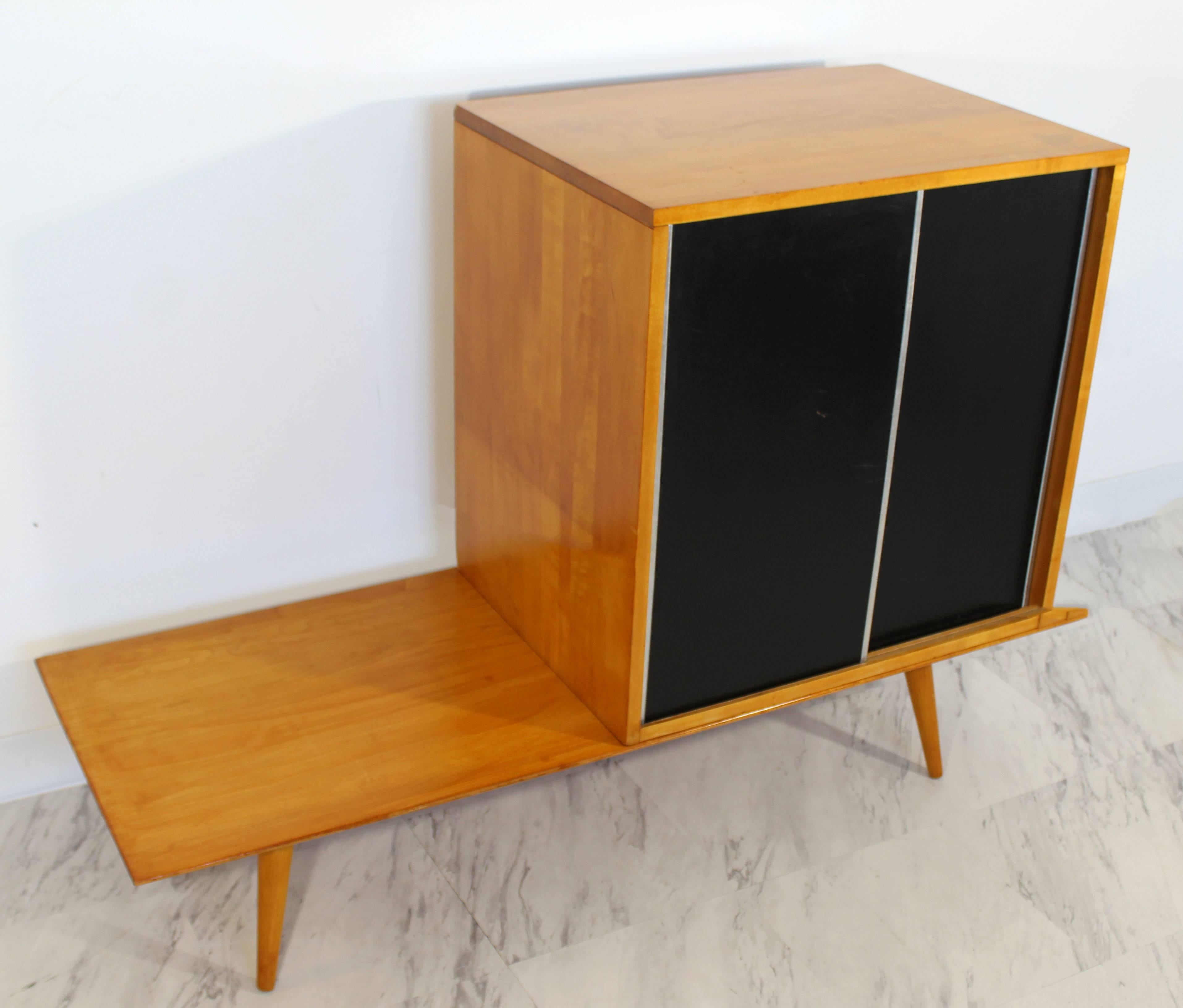 For your consideration is an incredible, coffee table or bench and cabinet with sliding doors, made of solid maple and with tapered legs, by Paul McCobb for Winchendon, circa the 1960s. In excellent condition. The dimensions of the table are 48
