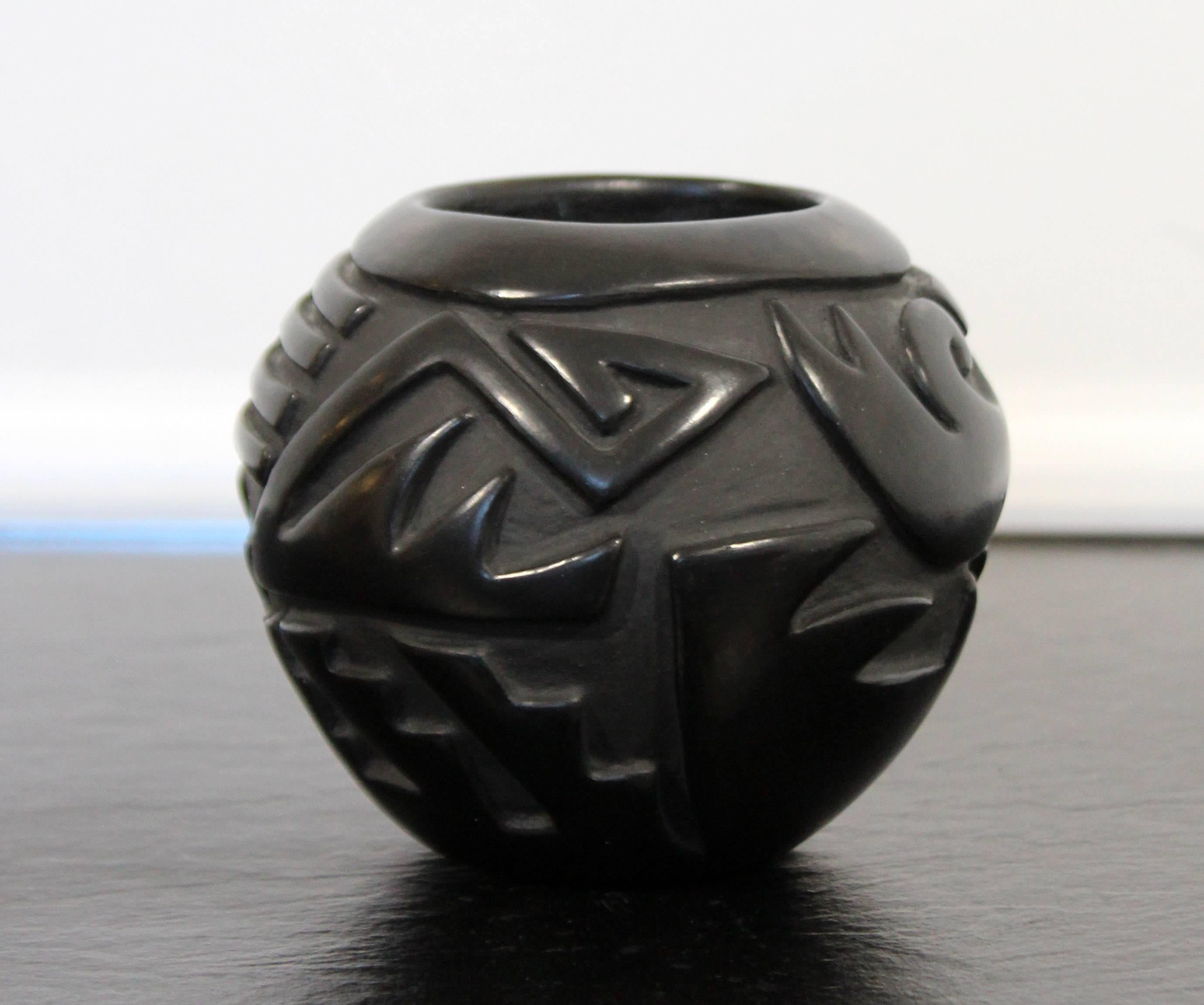Linda Cain is known for her abstract style pottery which utilizes modern shapes but traditional inspired imagery. She learned to make pottery from her mother Mary Cain and is a granddaughter of Christina Naranjo. This beautiful piece measures in at