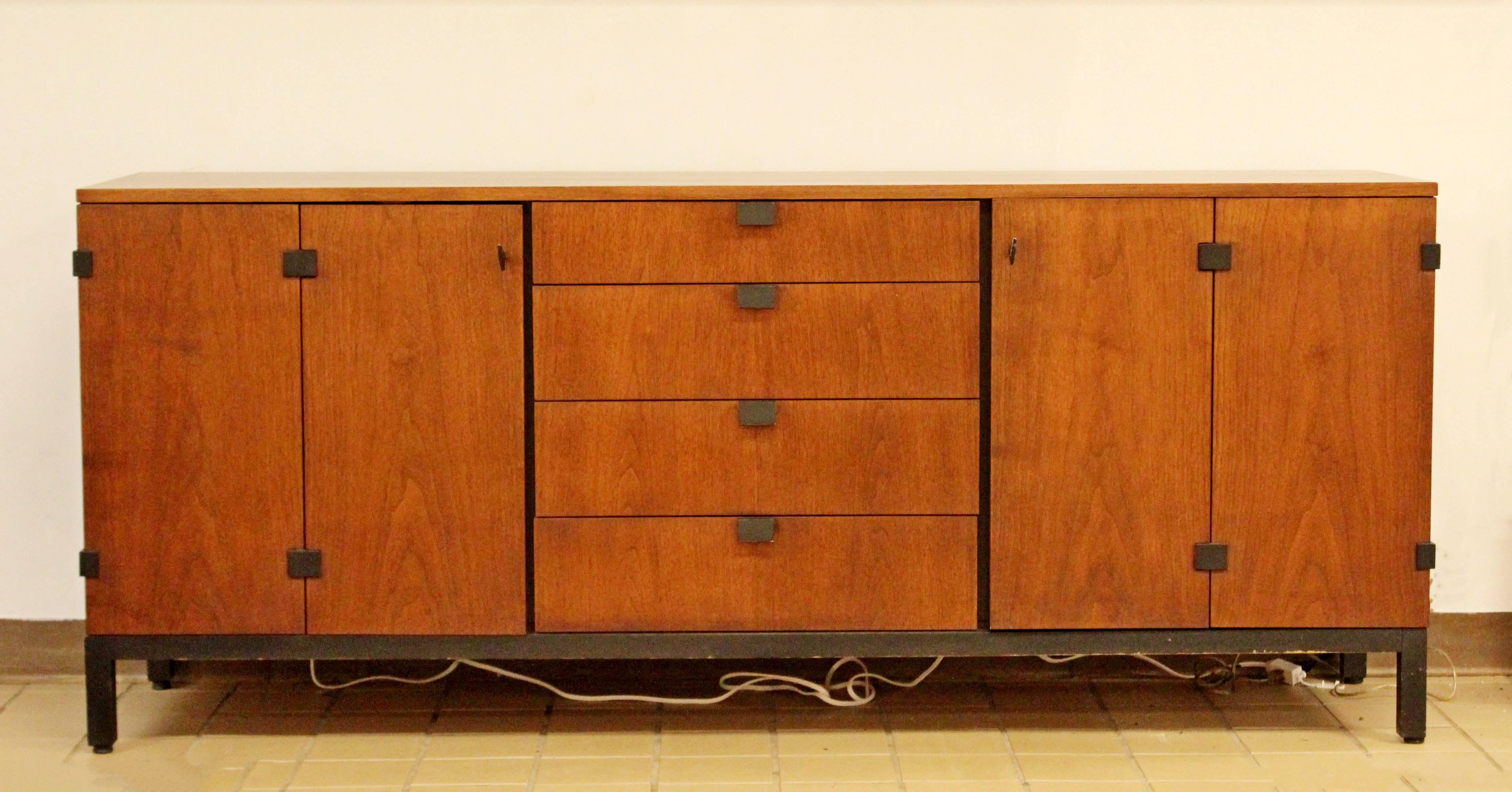 For your consideration is a gorgeous, walnut credenza, with four drawers and two storage spaces, by Kipp Stewart for Directional, circa the 1950s. In excellent condition. The dimensions are 72