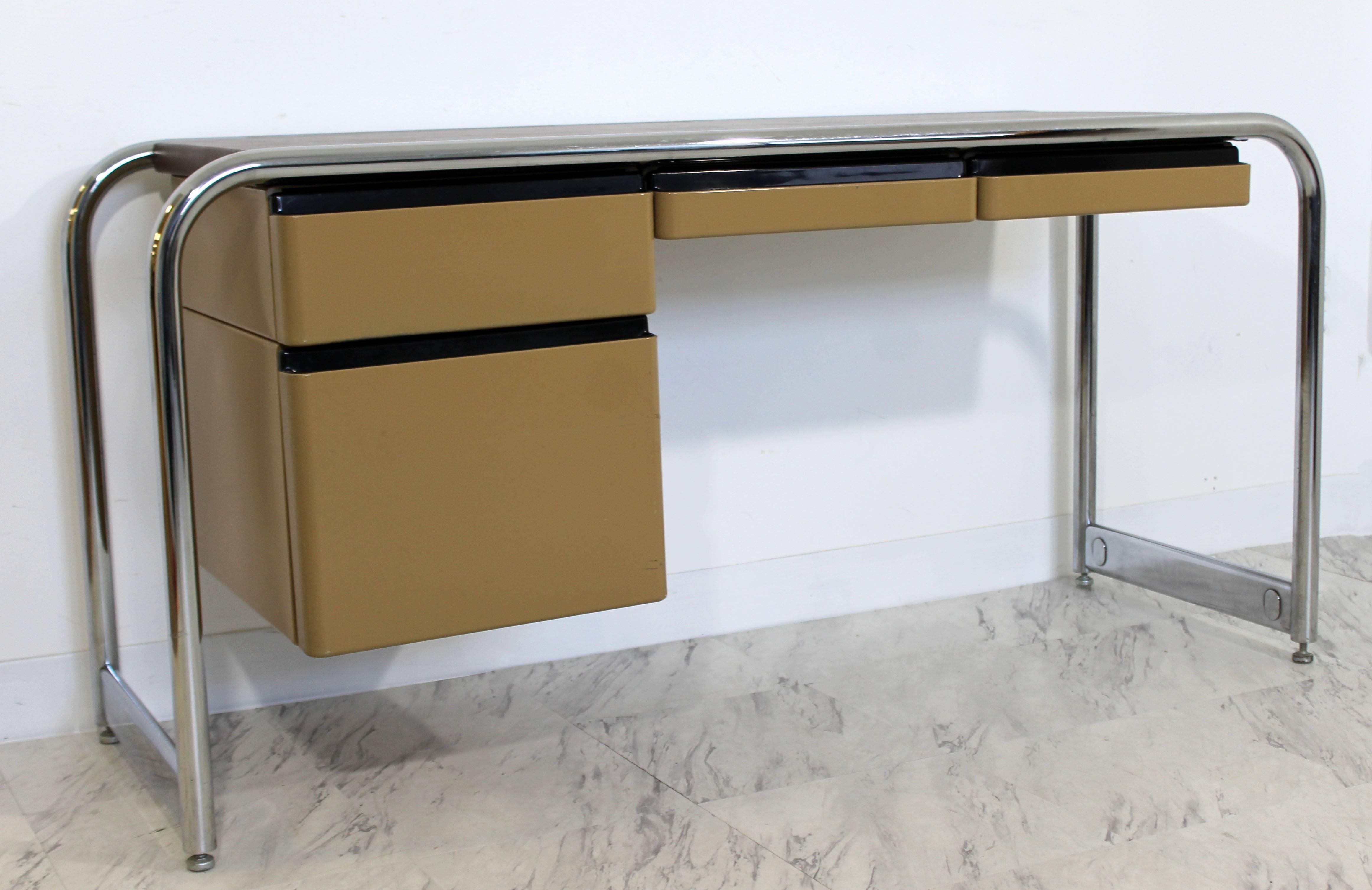 For your consideration is a fantastic, tubular chrome and metal, four drawer desk. With leather top by Michael Graves by Sunar Hauserman In excellent condition. The dimensions are 54