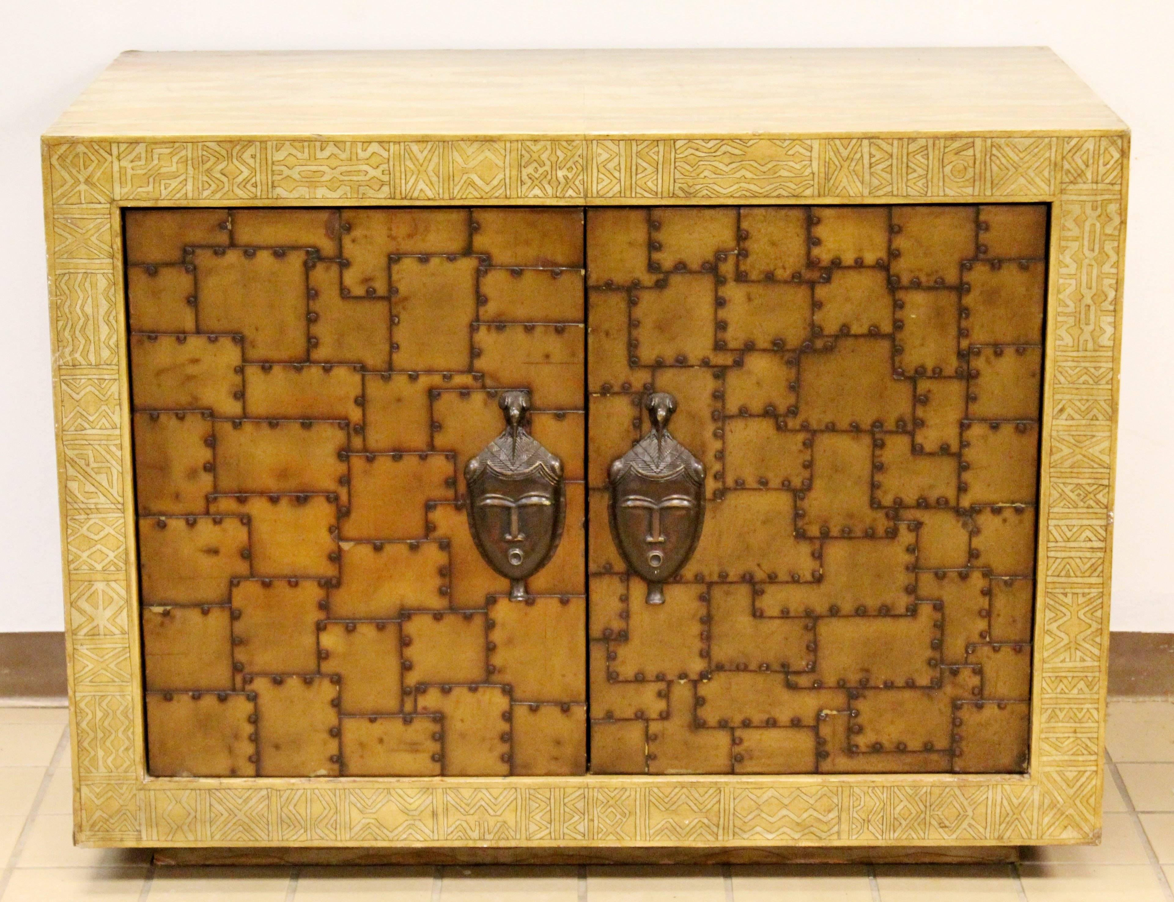 For your consideration is a phenomenally unique, Asian inspired, bronze and painted leather, small credenza or large chest, circa the 1970s. In excellent condition on the outside. The inside has been fitted with an electrical outlet, and has some