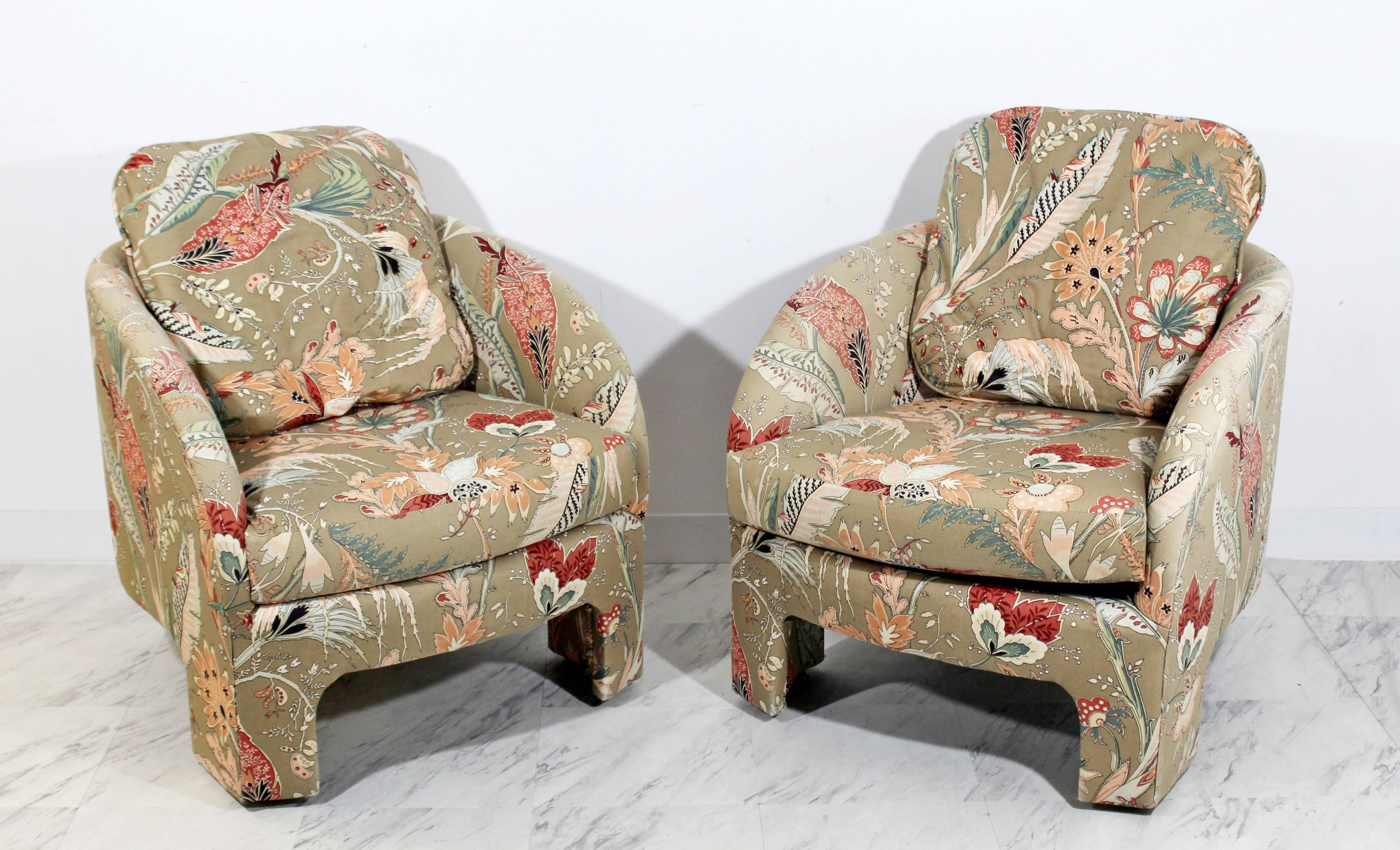 For your consideration is a gorgeous pair of architectural three-legged tub lounge arm chairs, with a floral upholstery, designed by Milo Baughman in the 1960s. In excellent condition. The dimensions are 27