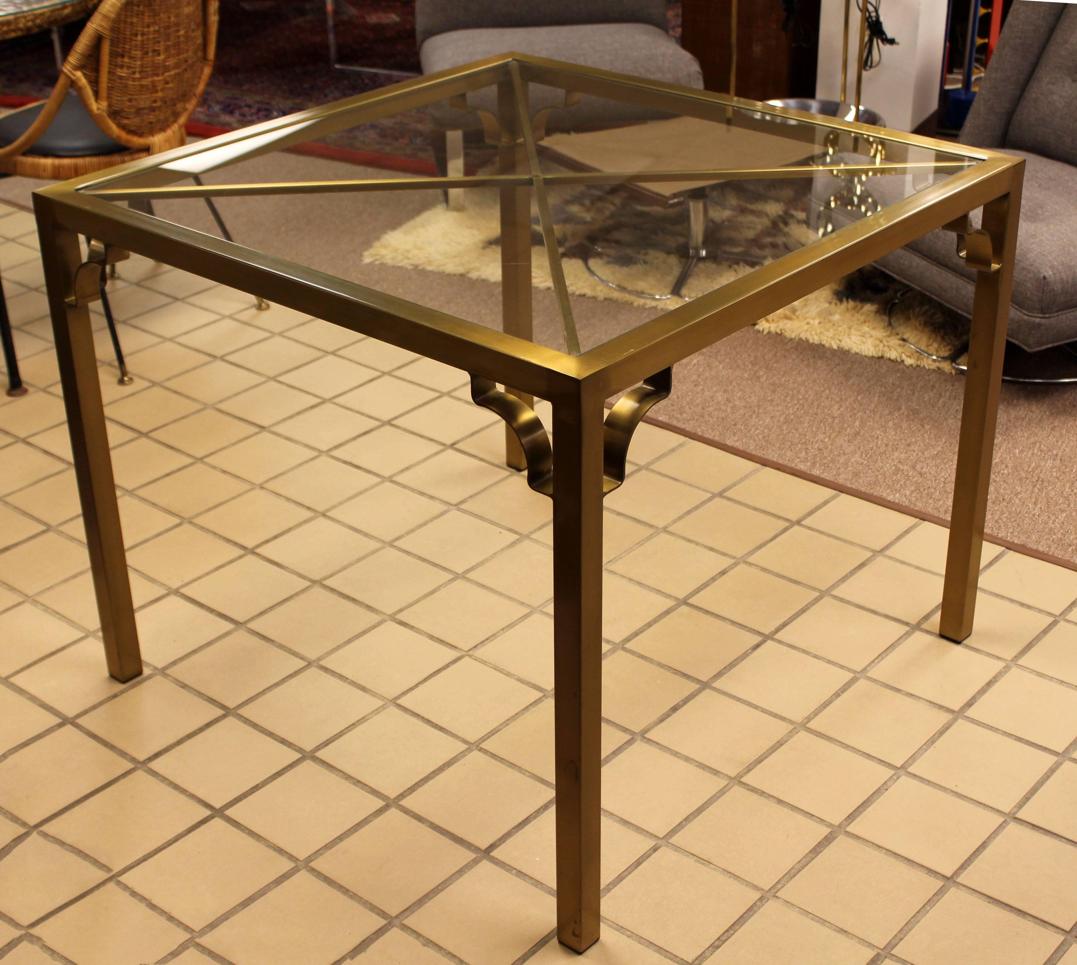 For your consideration is a sweet, brass and glass, dinette or game table attributed to Mastercraft, circa the 1970s. In excellent condition, with some minor surface scratches. The dimensions are 36