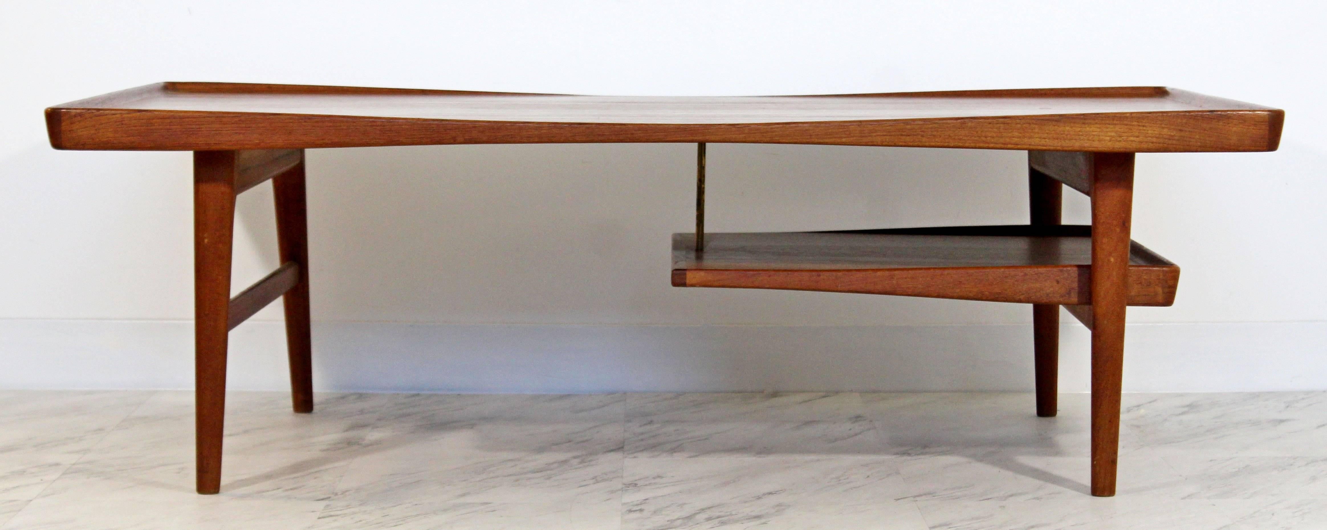 For your consideration is a magnificent, teak, coffee table, with a shelf, by Danish company Selig by Poul Jensen, circa 1960s. In excellent condition. The dimensions are 50