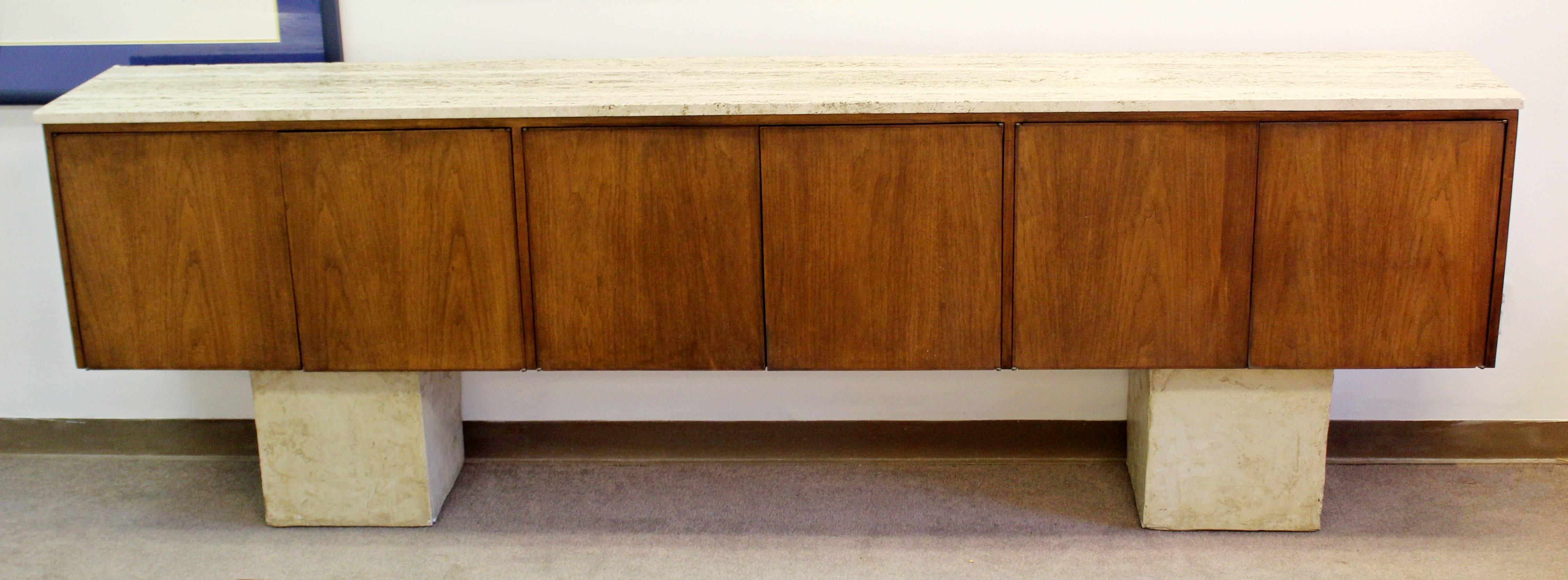 For your consideration is an amazing floating wall-mounted 9 feet long credenza, with a travertine top, attributed to either Florence Knoll or Harvey Probber. In excellent condition. It is shown in the pictures on top of two bases. The dimensions