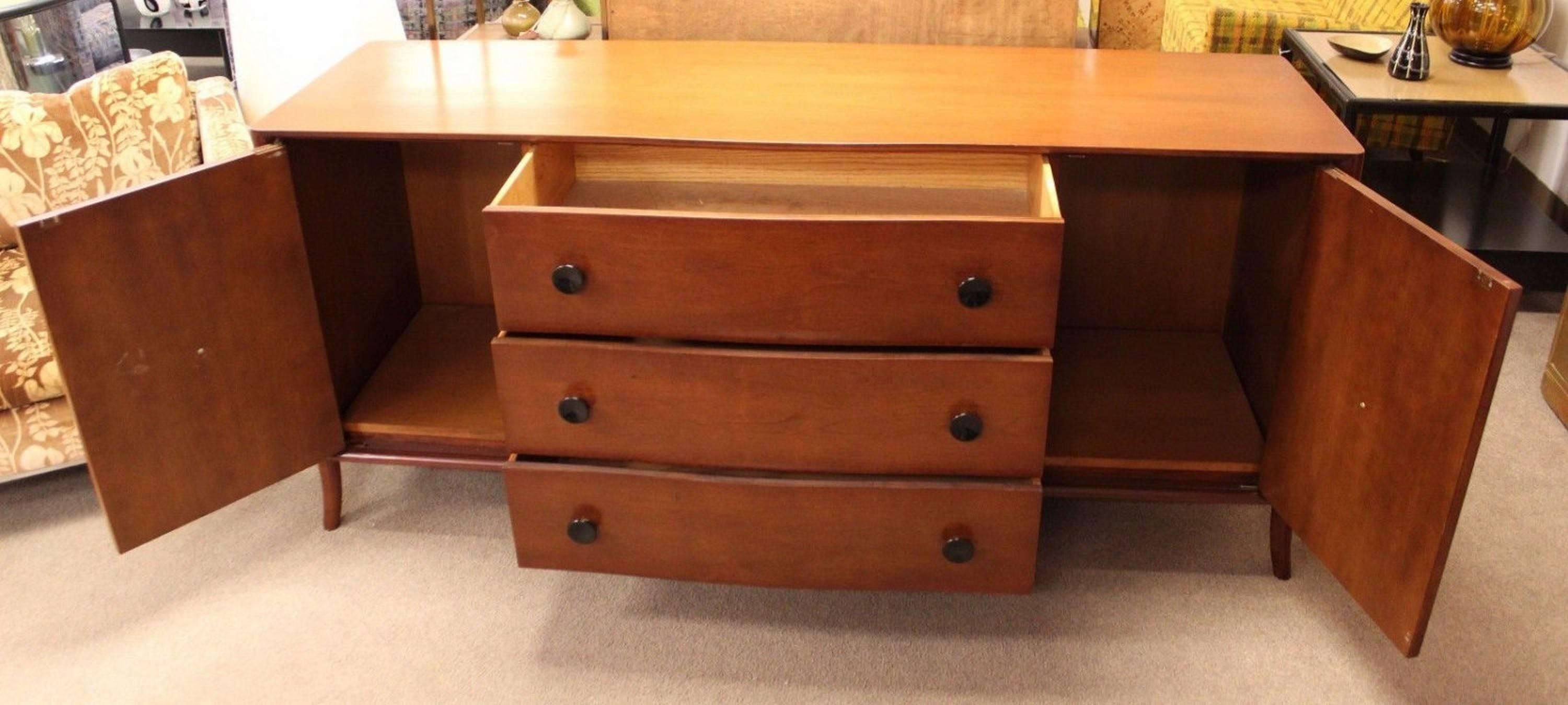 For your consideration is a wonderfully curved credenza by Robsjohn-Gibbings for Widdicomb. In excellent condition. With original tags. The dimensions are 70