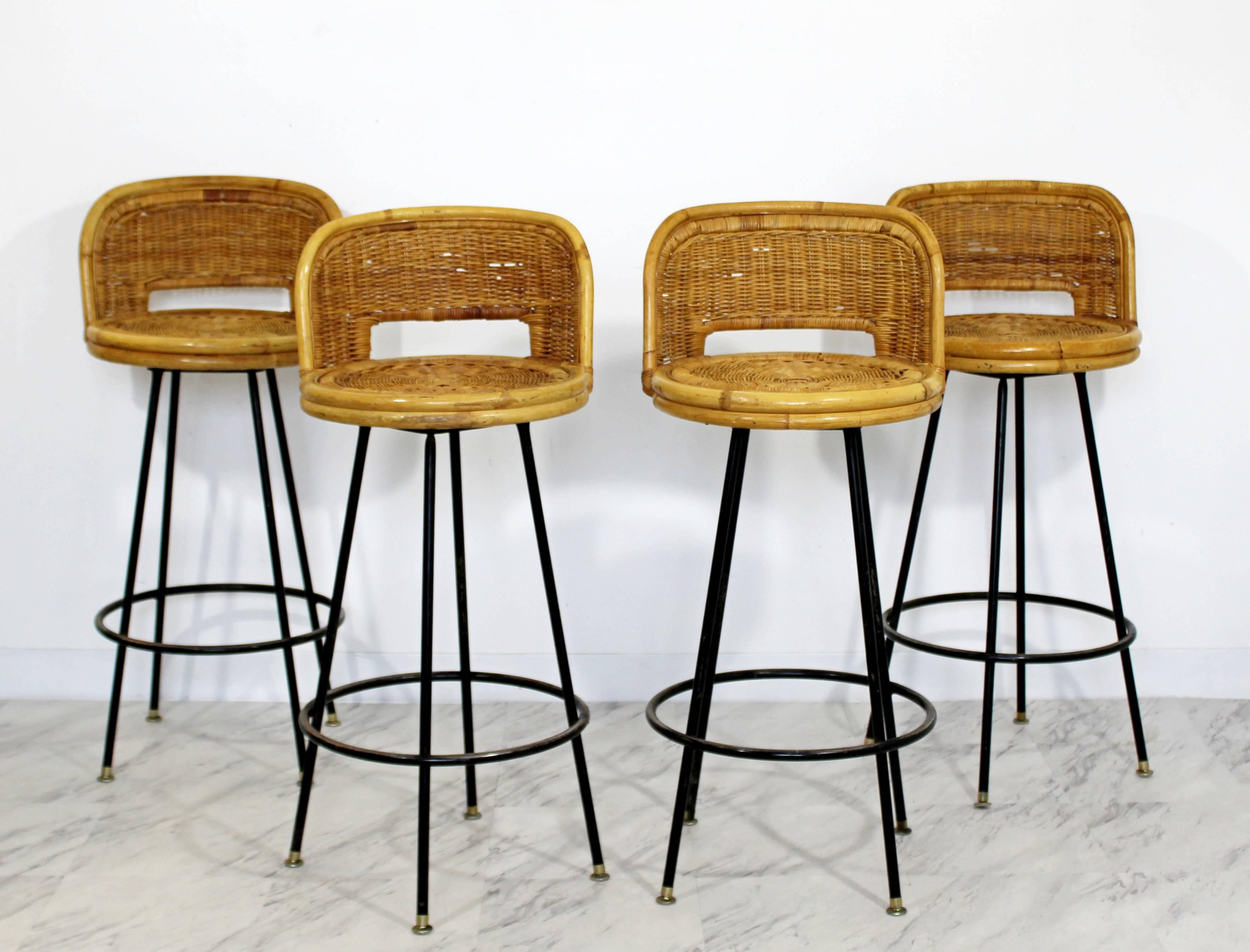For your consideration is a gorgeous, set of four bamboo rattan, swivel barstools by Danny Ho Fong, circa 1960s. In excellent condition. The dimensions are 17
