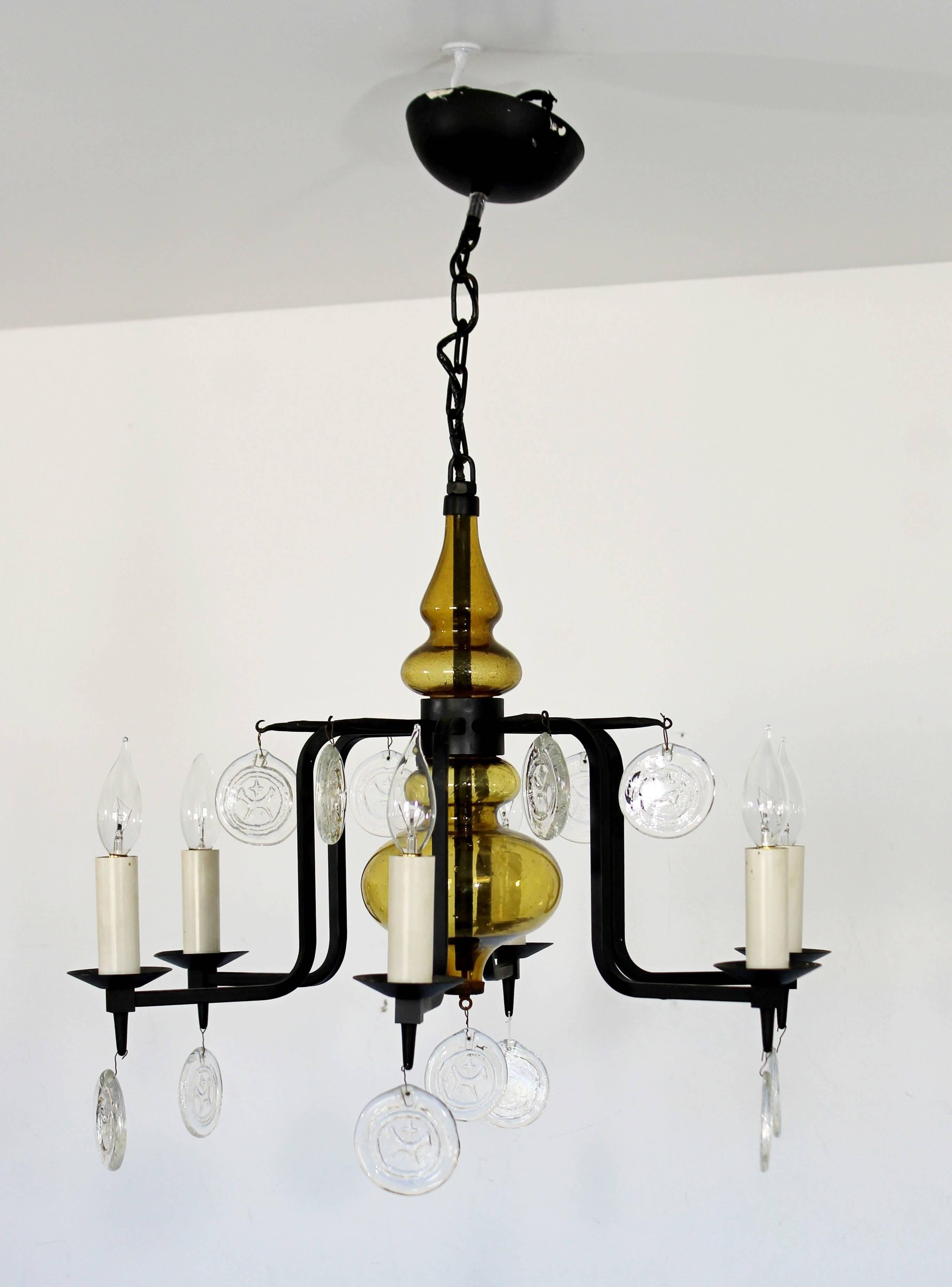 For your consideration is a dazzling, wrought iron chandelier, with yellow glass and clear glass, hanging medalions, by Svend Aage Holm Sorenson, circa the 1950s. In excellent condition. The dimensions are 22.5