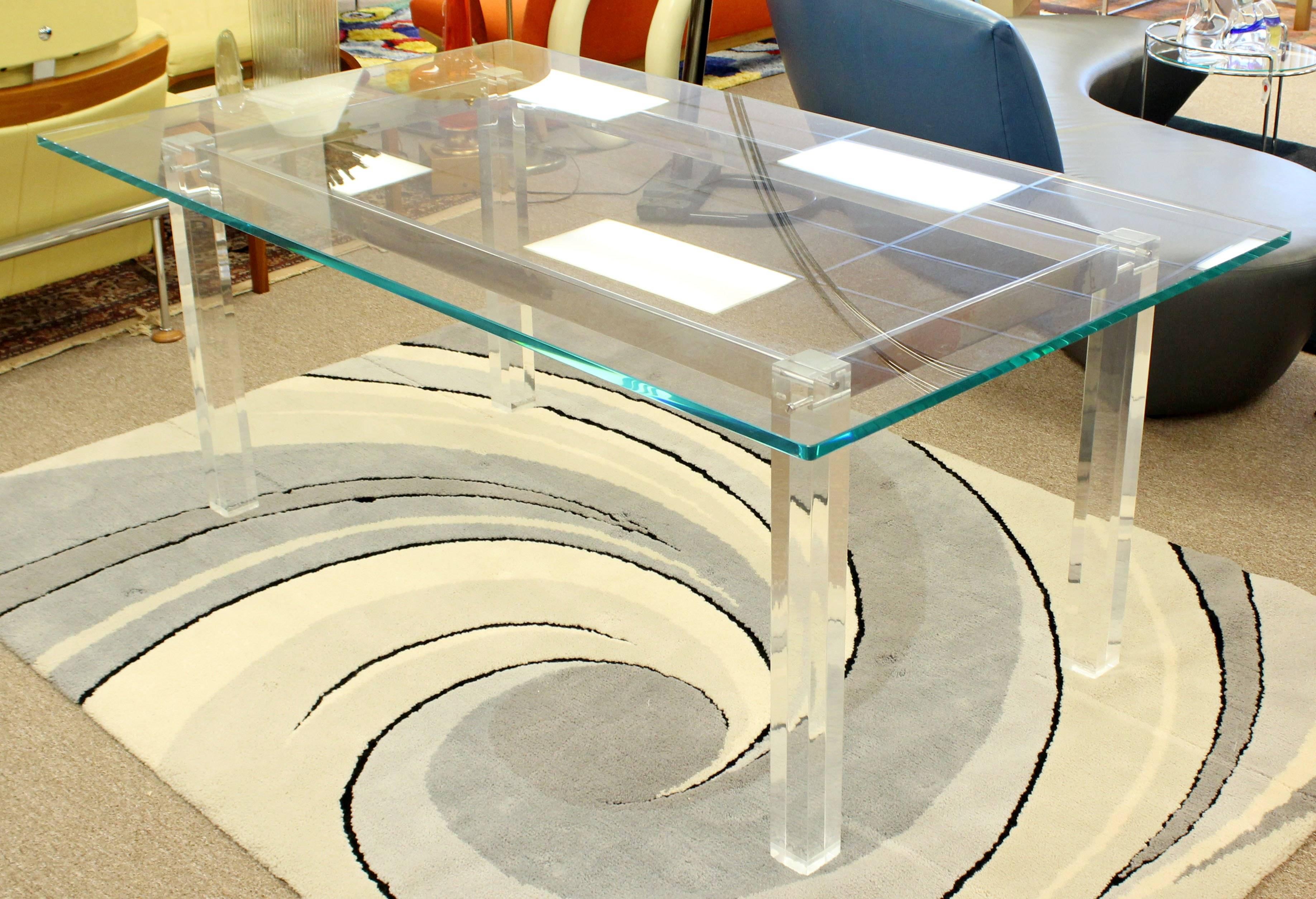 For your consideration is a fabulous, dining table, with a glass top, chrome base and Lucite legs, by Charles Hollis Jones, circa the 1970s. In excellent condition. The dimensions are 72
