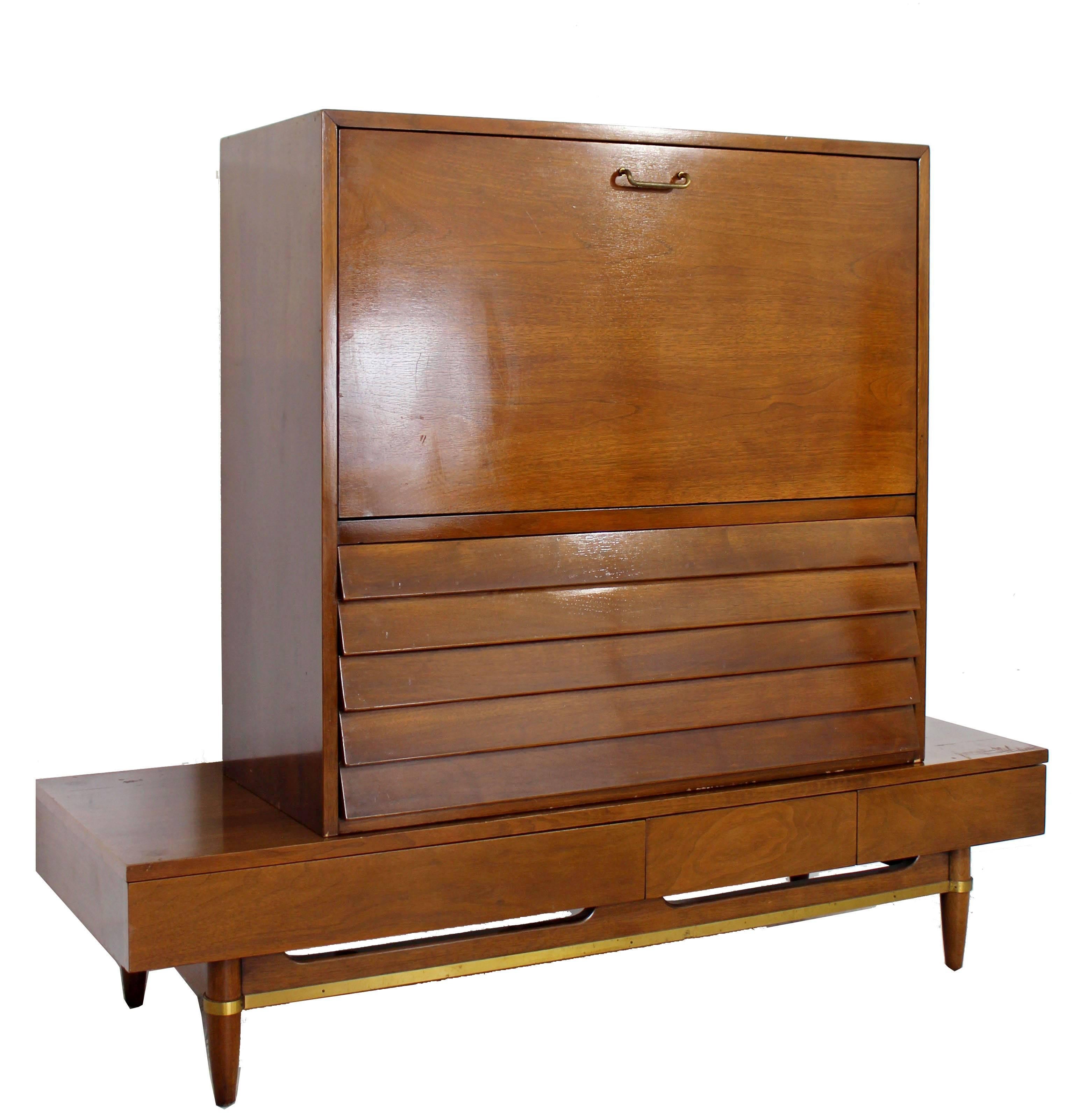 For your consideration is a tall, walnut secretary, with louvered drawers, brass trim and sculpted handles. This box and bench were designed by Merton Gershun for American of Martinsville, circa the 1970s. In excellent condition. The dimensions of