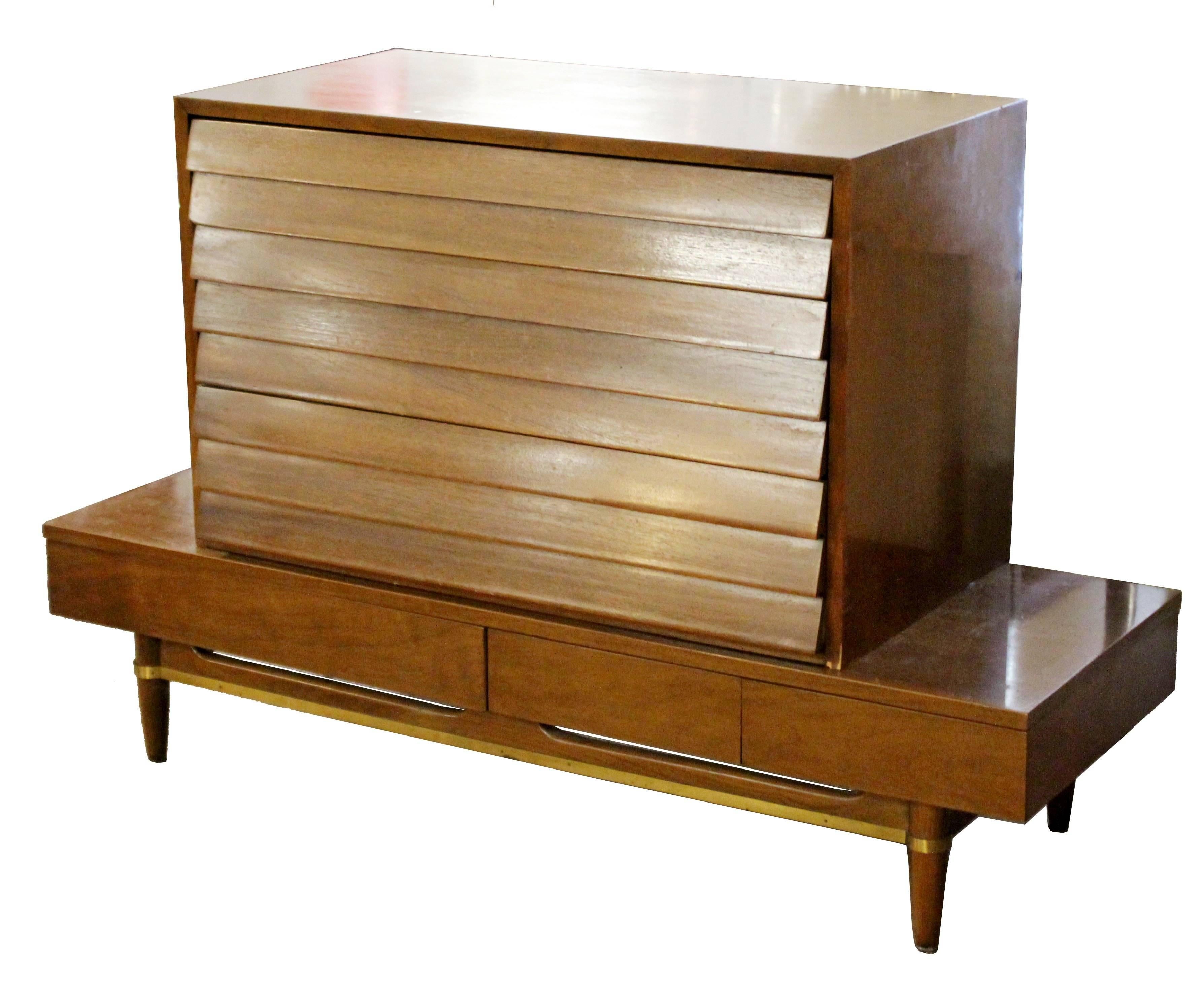 For your consideration is a gorgeous, walnut dresser, designed by Merton Gershun for American of Martinsville, circa 1970s. Top box has three louvered drawers and the bench or low console table has three drawers and brass trim. In excellent