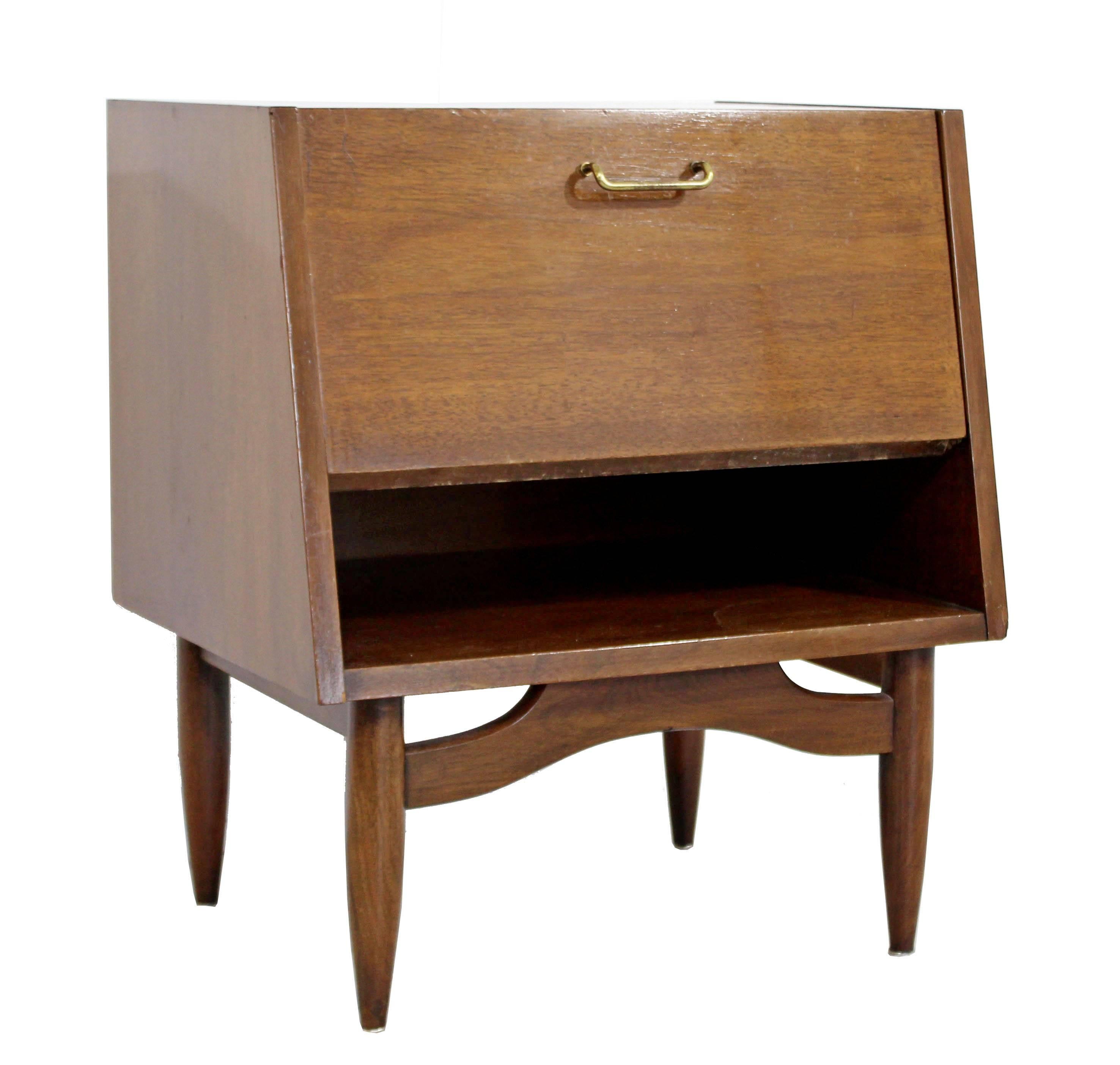 For your consideration is a sweet, little, walnut nightstand, with brass accents, by Merton Gershun for American of Martinsville, the Dania collection, circa the 1970s. In excellent condition. The dimensions are 22