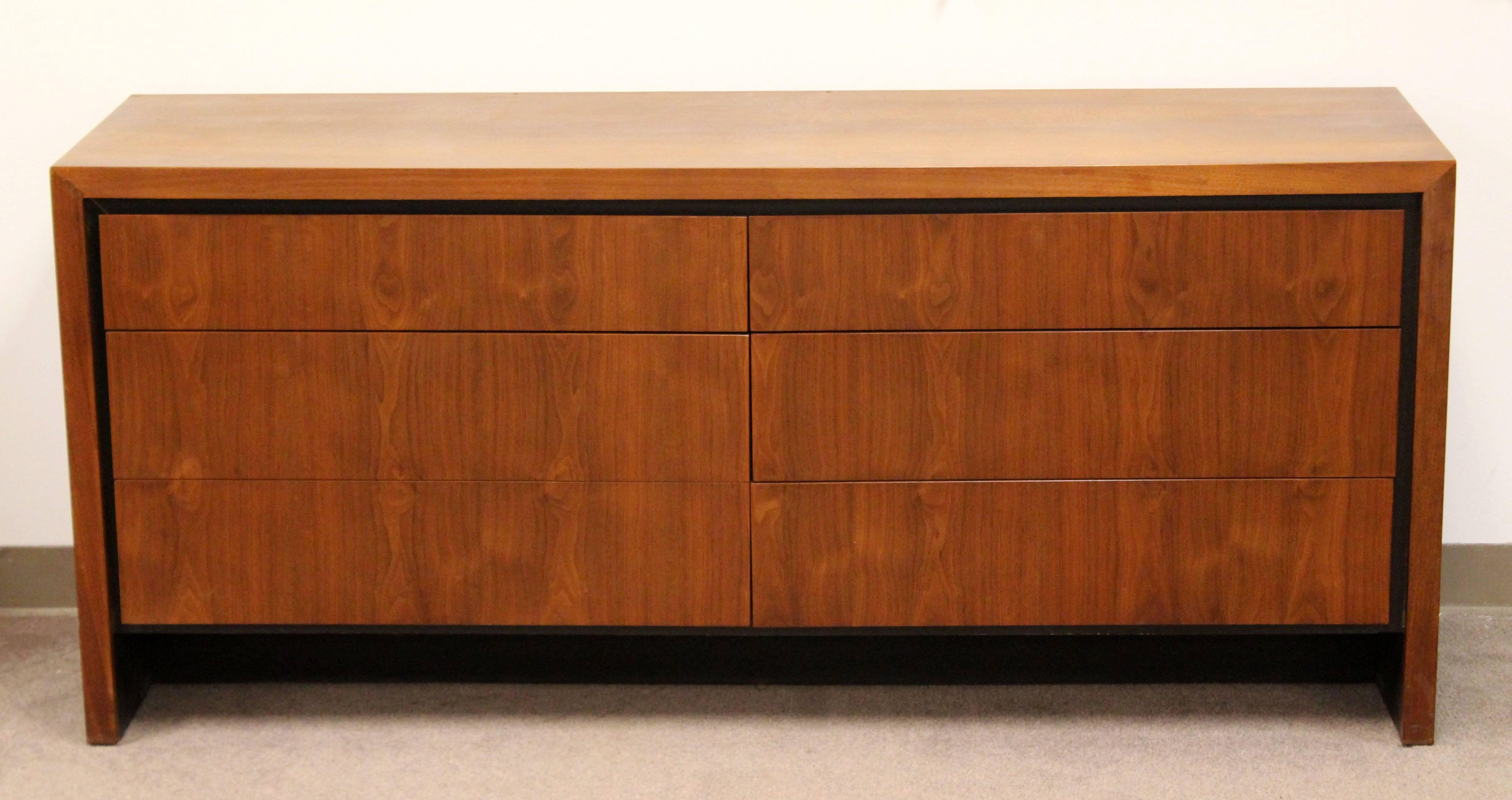 For your consideration is a gorgeous, walnut, six drawer dresser or credenza with black trim, designed by Merton Gershun for Dillingham, circa 1960s. In excellent condition. The dimensions are 66