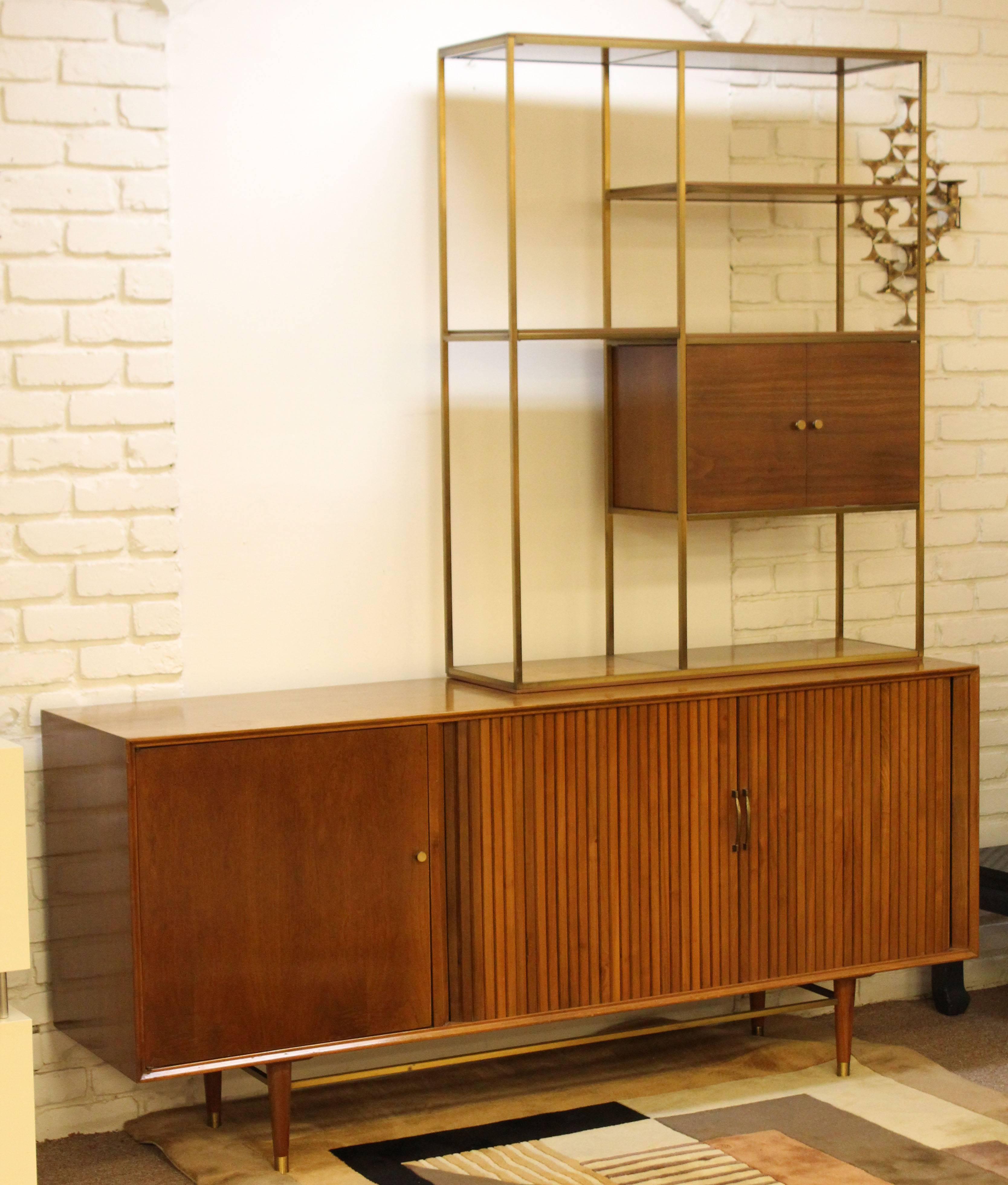 For your consideration is a magnificent, brass and walnut, credenza and shelving unit, by Furnette, in the style of Paul McCobb. In excellent condition. The dimensions of the credenza are 72