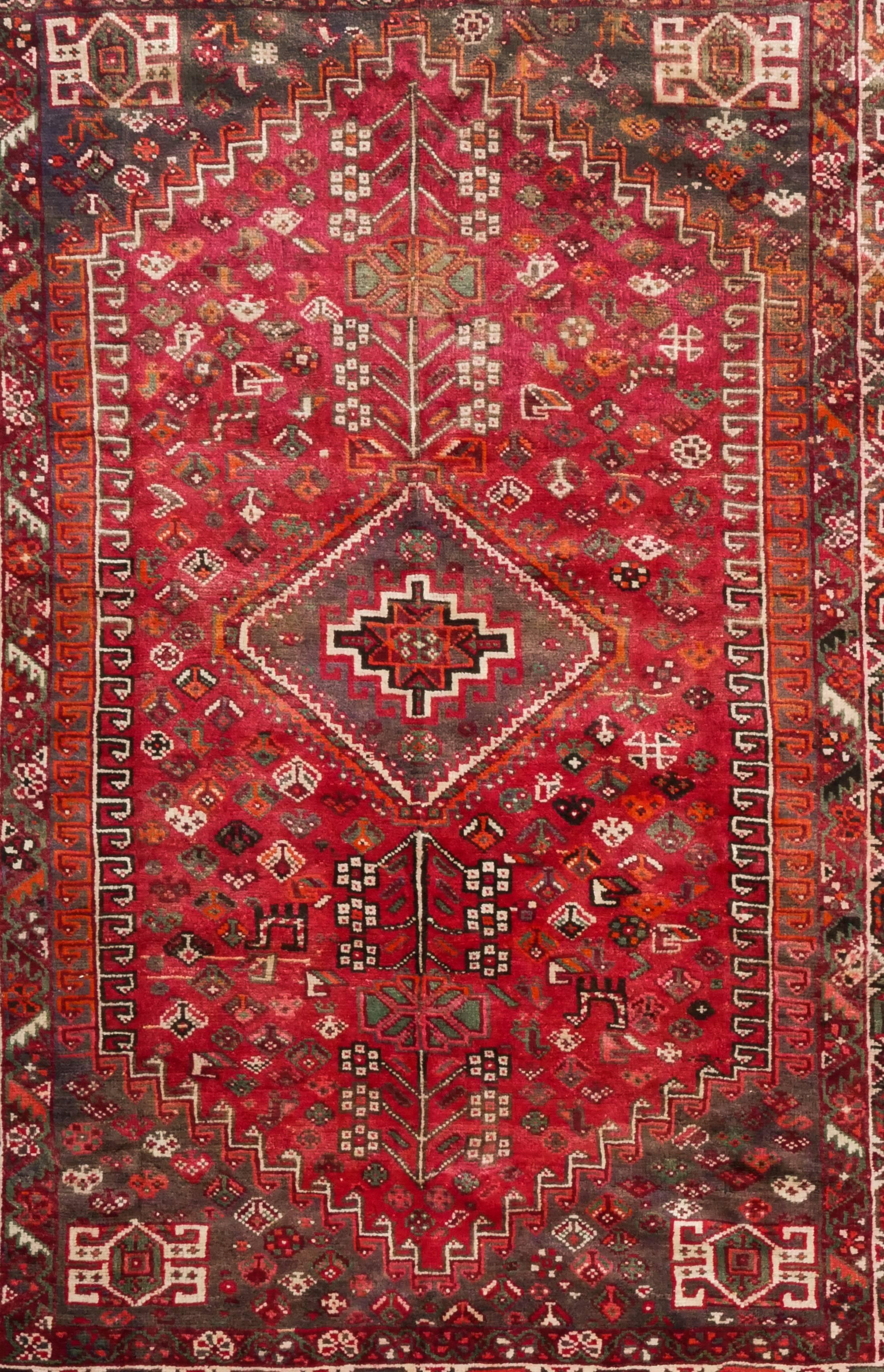 This is a lovely and colorful Persian village Abadeh carpet in wool and goat's hair
It features a nomadic (geometric) medallion and a host of symbolic motifs
The colors are vivid and range from ruby and sunset reds, orange and ivory, some blues in