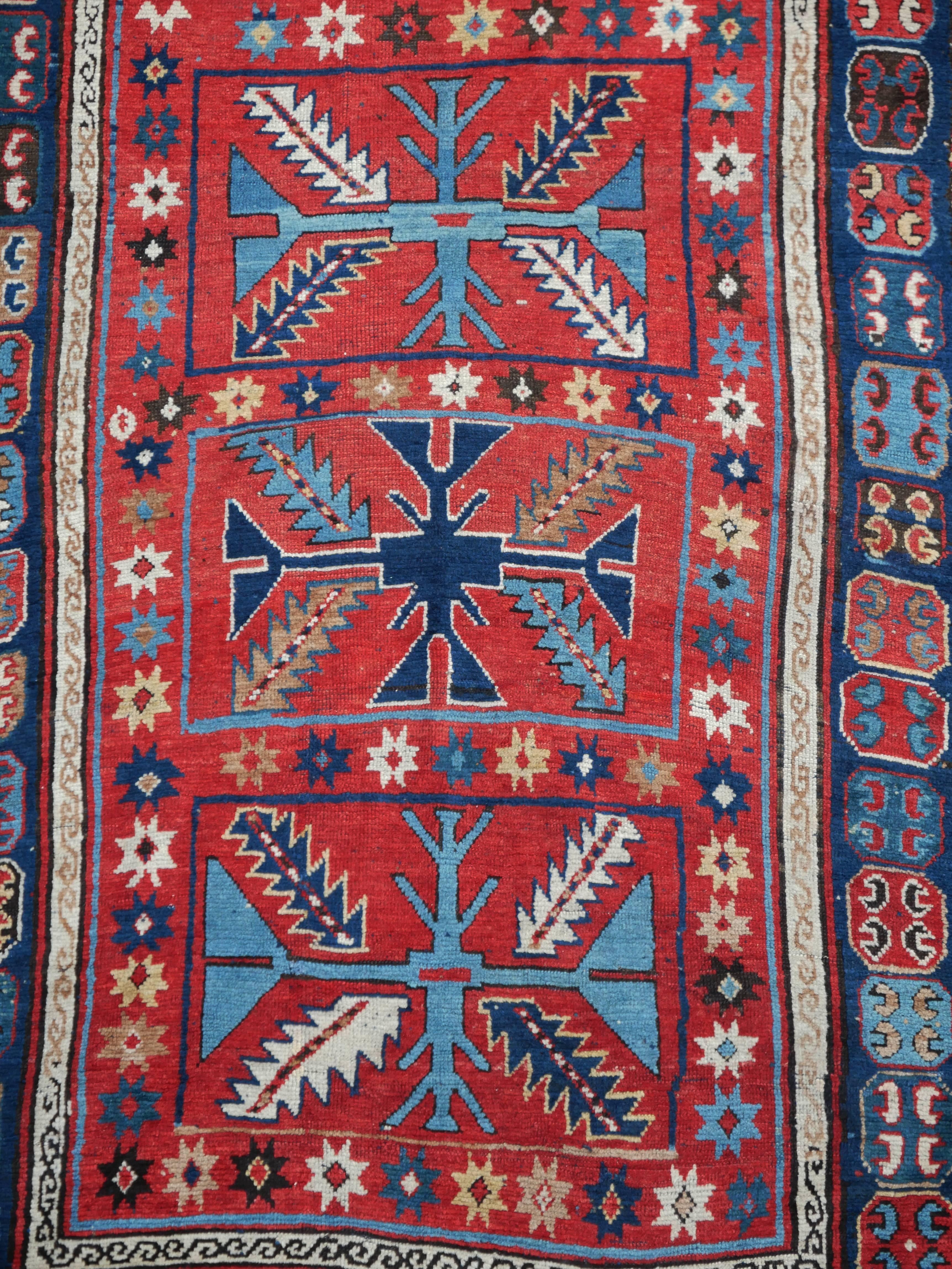 An antique Caucasian carpet Kasak (southwest Caucasus).
Red-ground Kasak with elegant three cross medallions flanked by colorful leaves.
Rare main border with small octogons and so-called
C-Gül's motifs also called horseshoe motifs.
Age: around