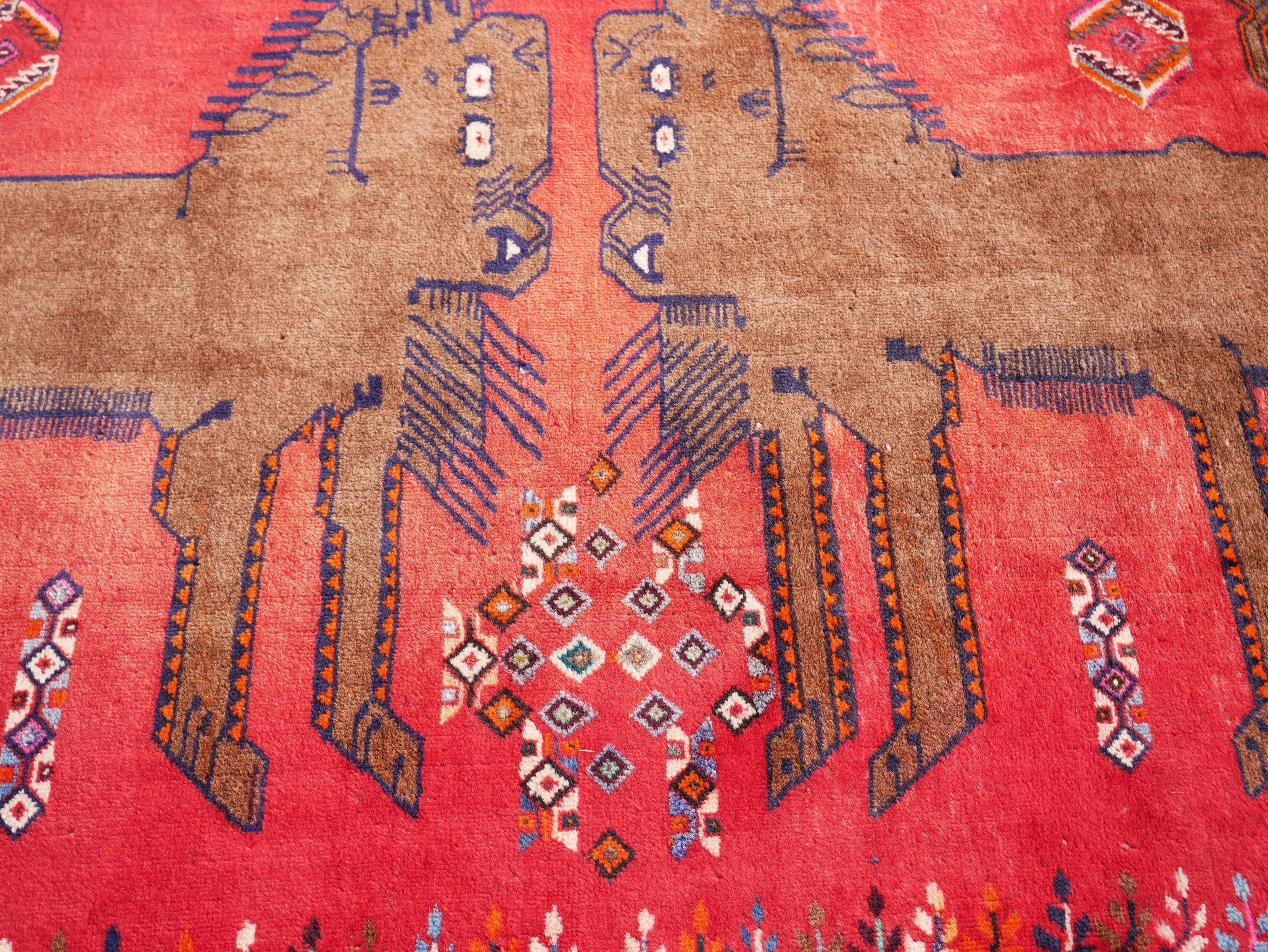 This is a gorgeous all-wool pictorial Qashqai gabbeh featuring lions (a very important motif in nomadic mythology of the Fars region in Iran) set in an sunset red field. 
Size: 6.9'x45' or 210x136cm

 