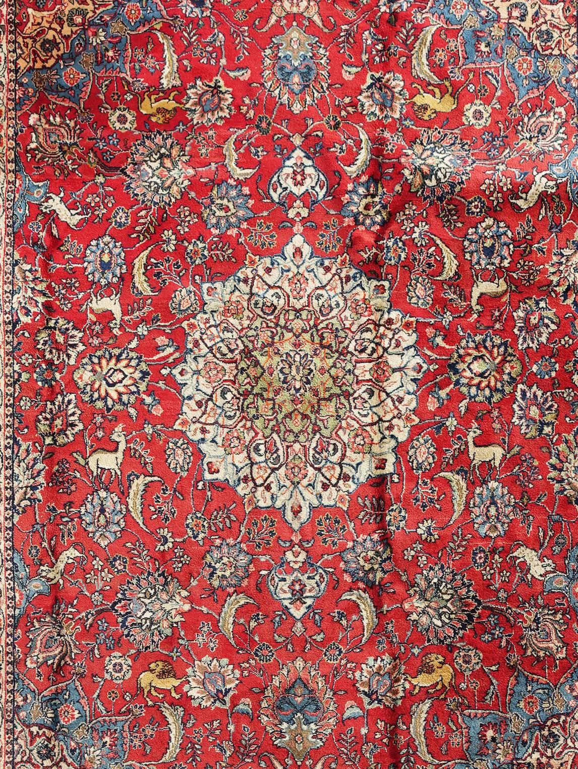 This modern (circa 1970) hand-knotted Persian Sarouq was bought and imported to Europe from an American collector. It is the finest example of carpet artistry tradition dating back several hundreds of years. The bold colors and the symbolic display