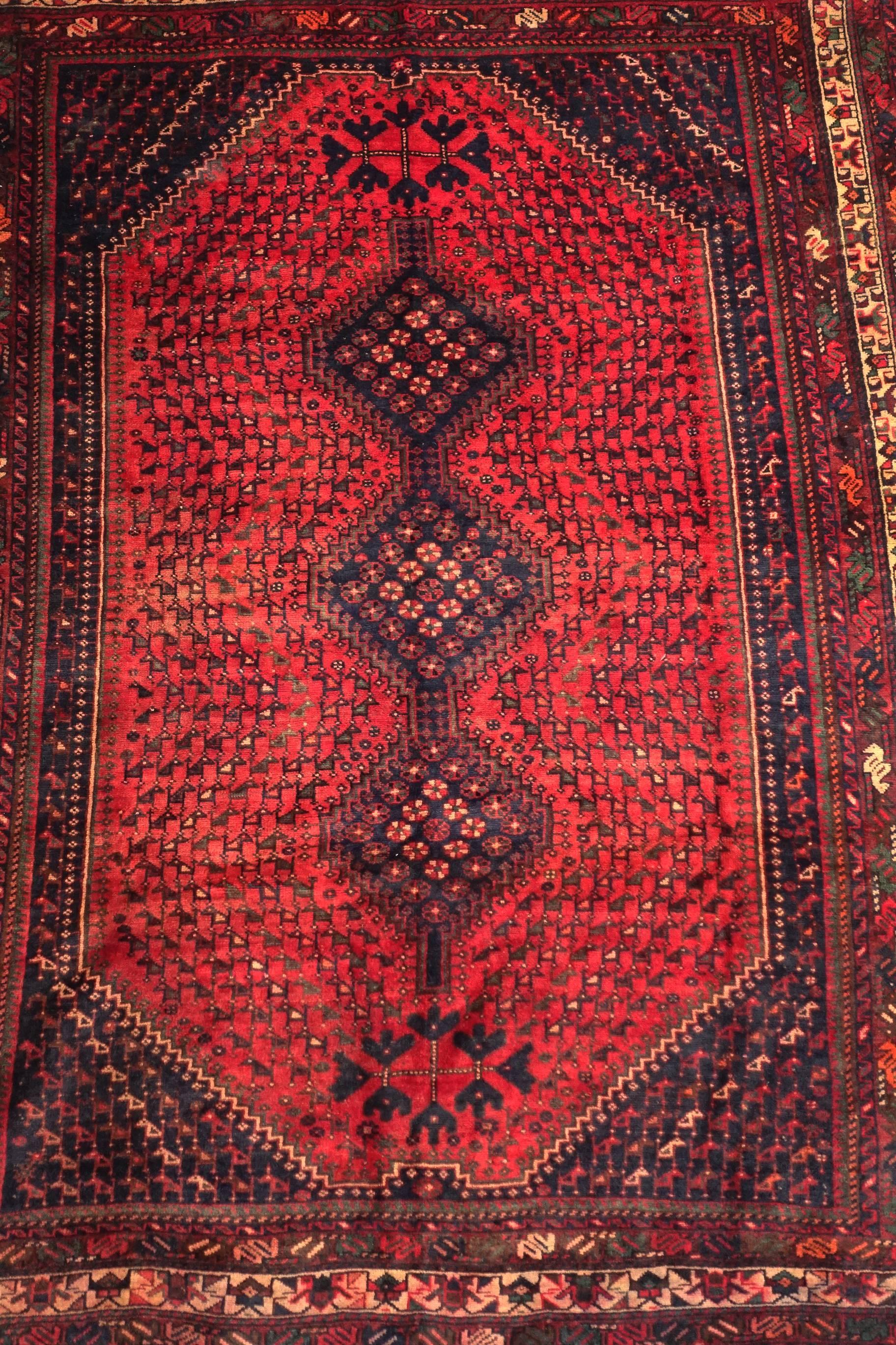 This is a beautifully preserved genuine Qashqai rug produced in the Zagros Mountains in south-western Iran. Apart from the Classic three-serrated medallion lozenge, it features field replete with an array of avian motifs. 
Size: c. 275 x 203cm or