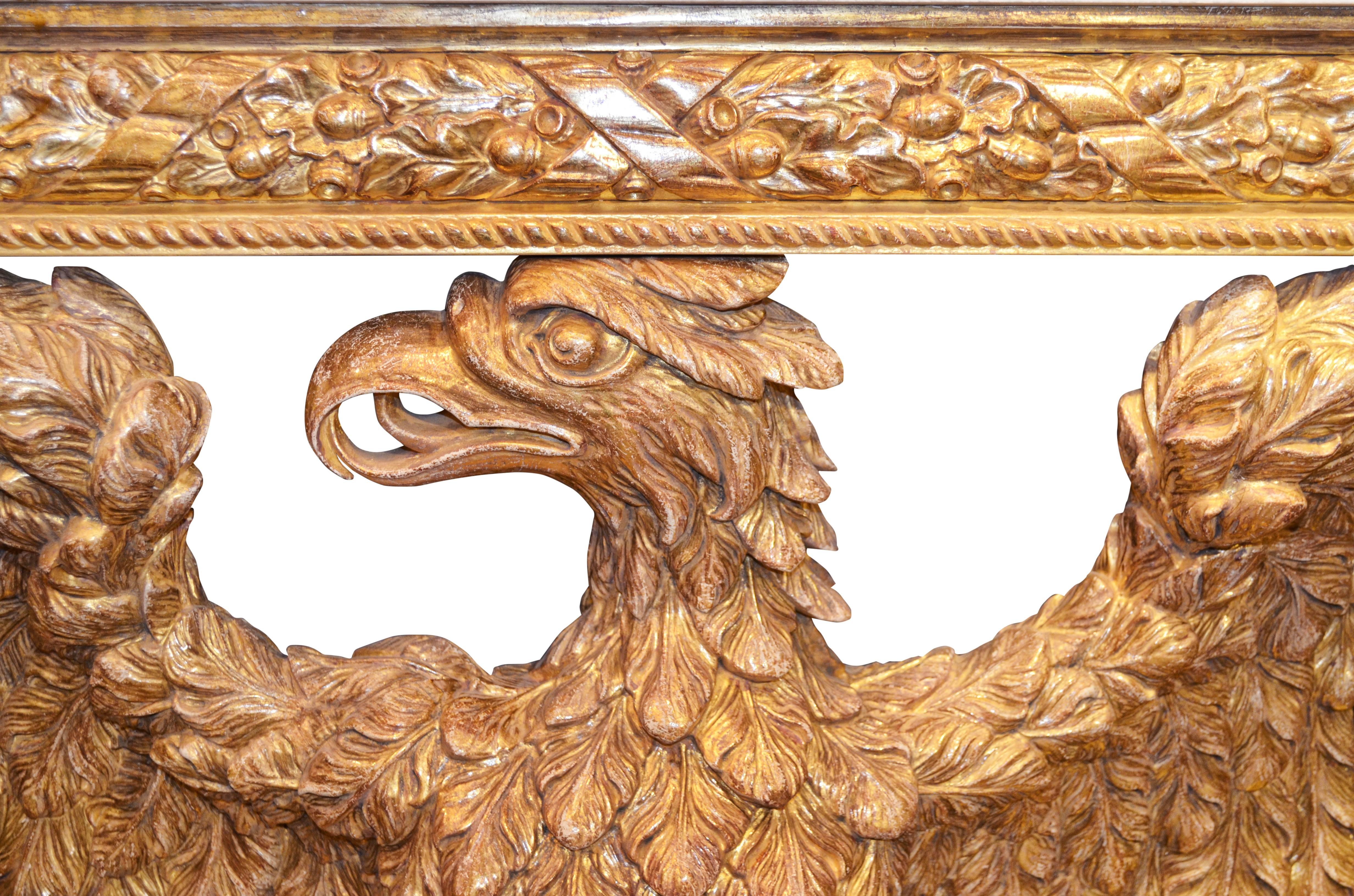 A wonderful and impressive pair of William Kent (mid-1700s) designed eagle console tables. Finely hand-carved and hand gilded using 23-carat gold-leaf with exceptional detail and completed with thick cut white Carrara marble tops.