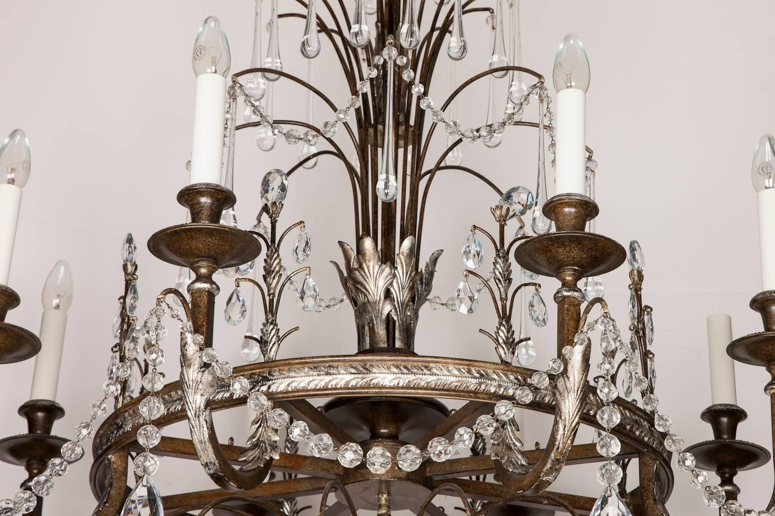An eight light Swedish style, silver-leaf and bronze chandelier draped in glass tear drops, pear drops and glass beads, circa 1980s.