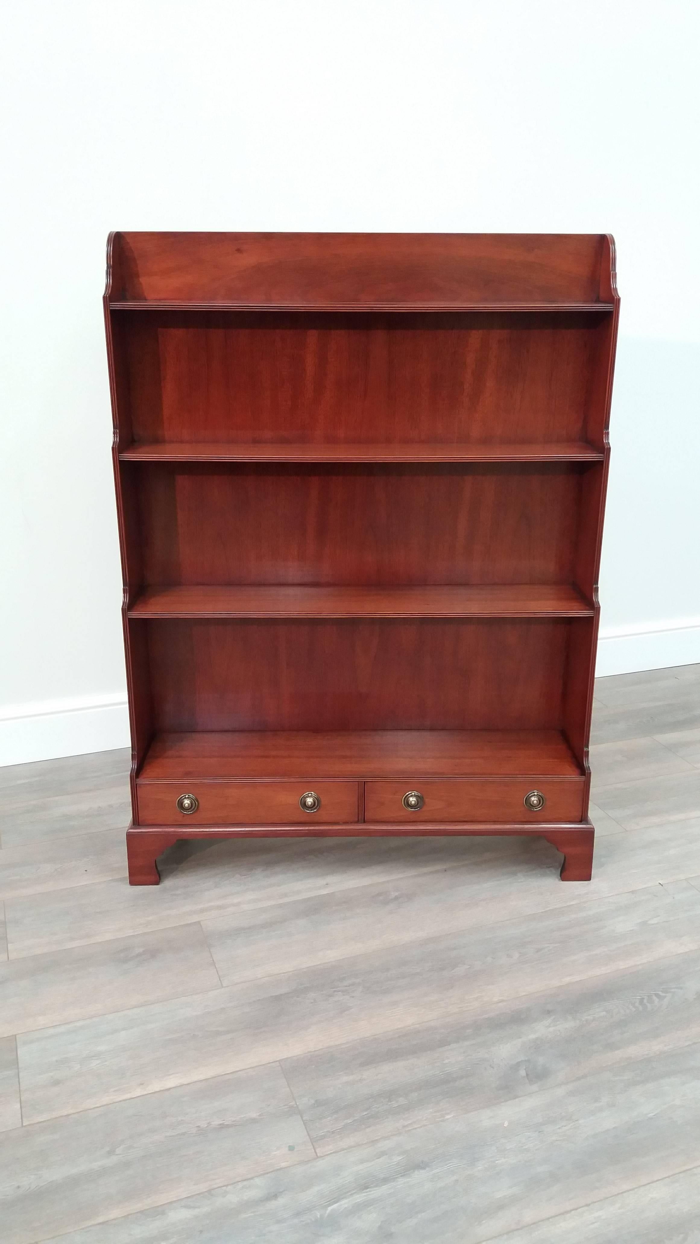 A mahogany open bookcase on bracket feet with four graduated shelves above two drawers.

Arthur Brett is a long-established English cabinet making business producing high quality furniture, specializing in bespoke commissions and renowned for its