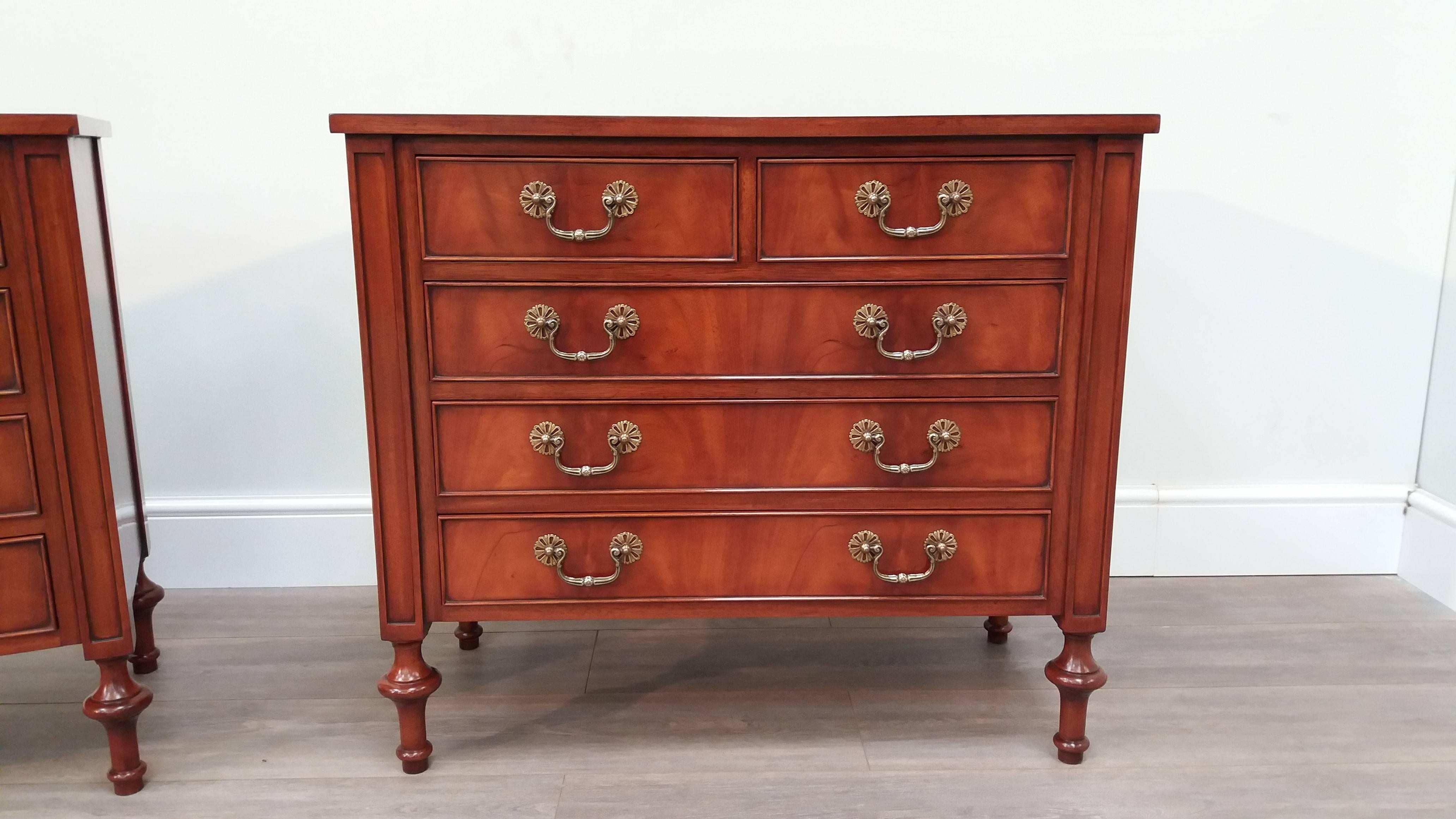 Two similar figured mahogany bedside chests sitting on turned solid mahogany legs.  Featuring two short drawers over four long drawers with brass handles.

Featuring figured mahogany top and brass handles. Supported by four hand-turned mahogany