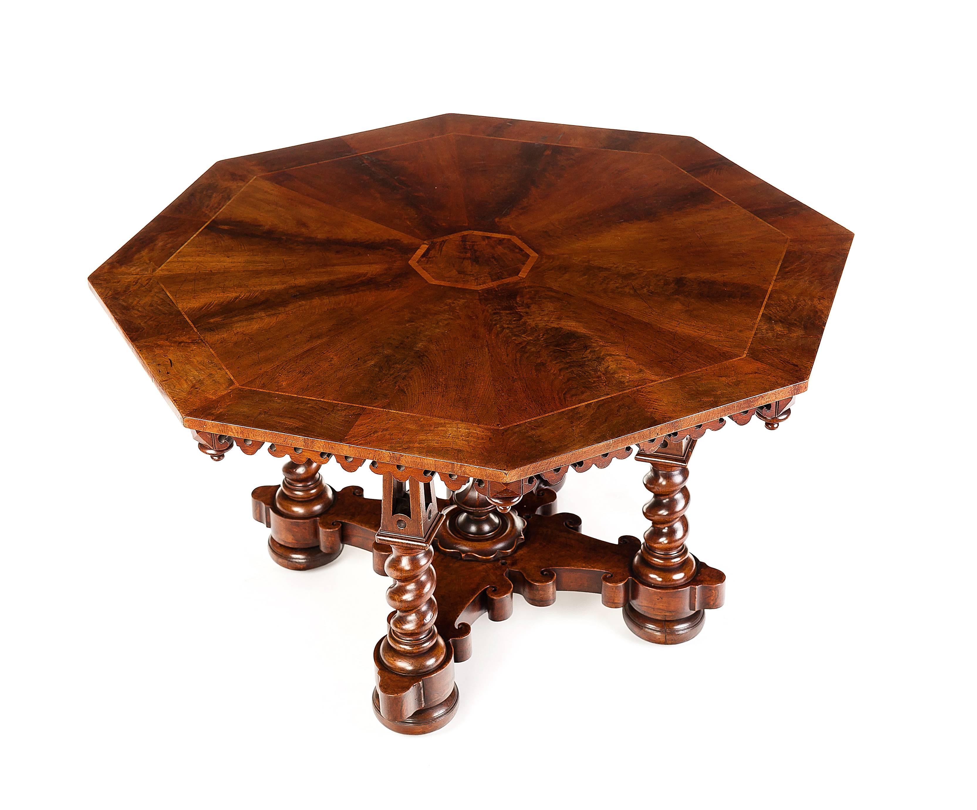 An early Victorian walnut and ash banded centre table attributed to Thomas Willement (1786-1871), the banded top with a central octagonal medallion and a pierced scroll work pendant frieze on four pieced spire and twist supports and a scrolling
