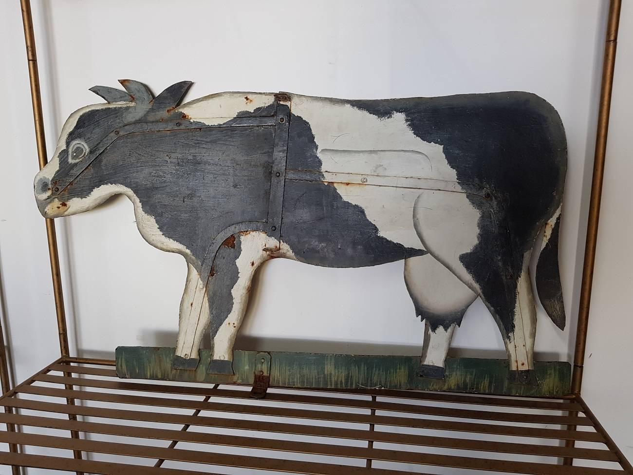 Metal painted weather vane in the form of a cow, this one is made circa 1900, the parts are nailed to each other and then hand-painted. Truly a unique piece of home Folk Art from a farm, great as decoration in any interior or exterior.

The