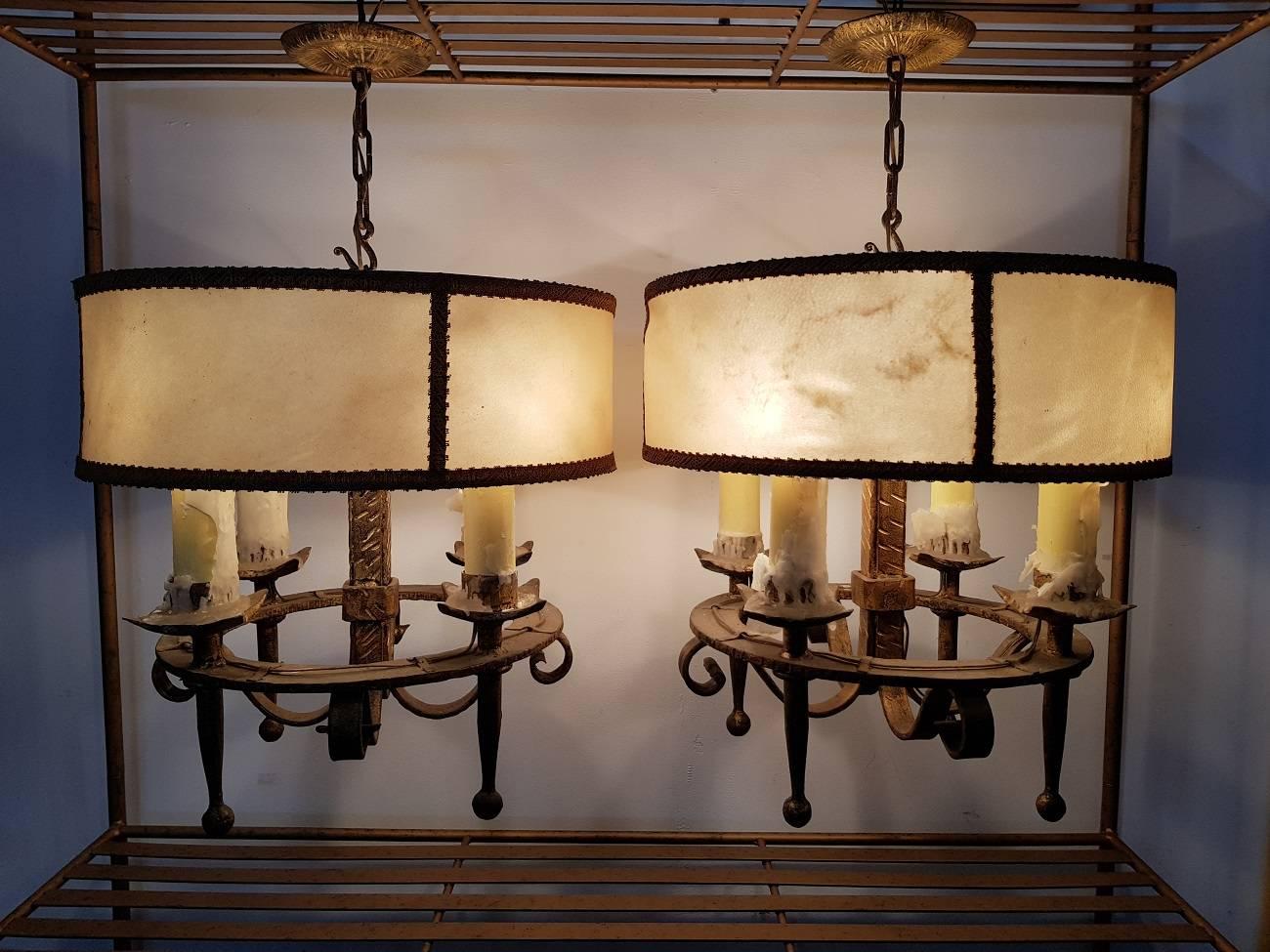 Two vintage Spanish light fixtures marked by Ferro Art, circa 1960, they are made of gilded forged iron and both with the original lampshade of animal skin. The have wooden candle sleeves with a E14 lamp fitting.

The measurement are,
Depth 38