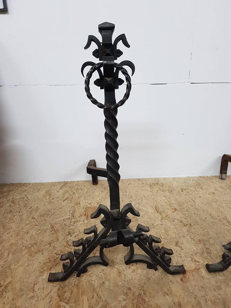Two large French Gothic style andirons or chenets, made of forged metal with burled twisted and rough looking elements. They are from circa 1950-1960 and in a fair condition.

The measurements are:
depth 74 cm/ 29.1 inch.
width 46 cm/ 18.1