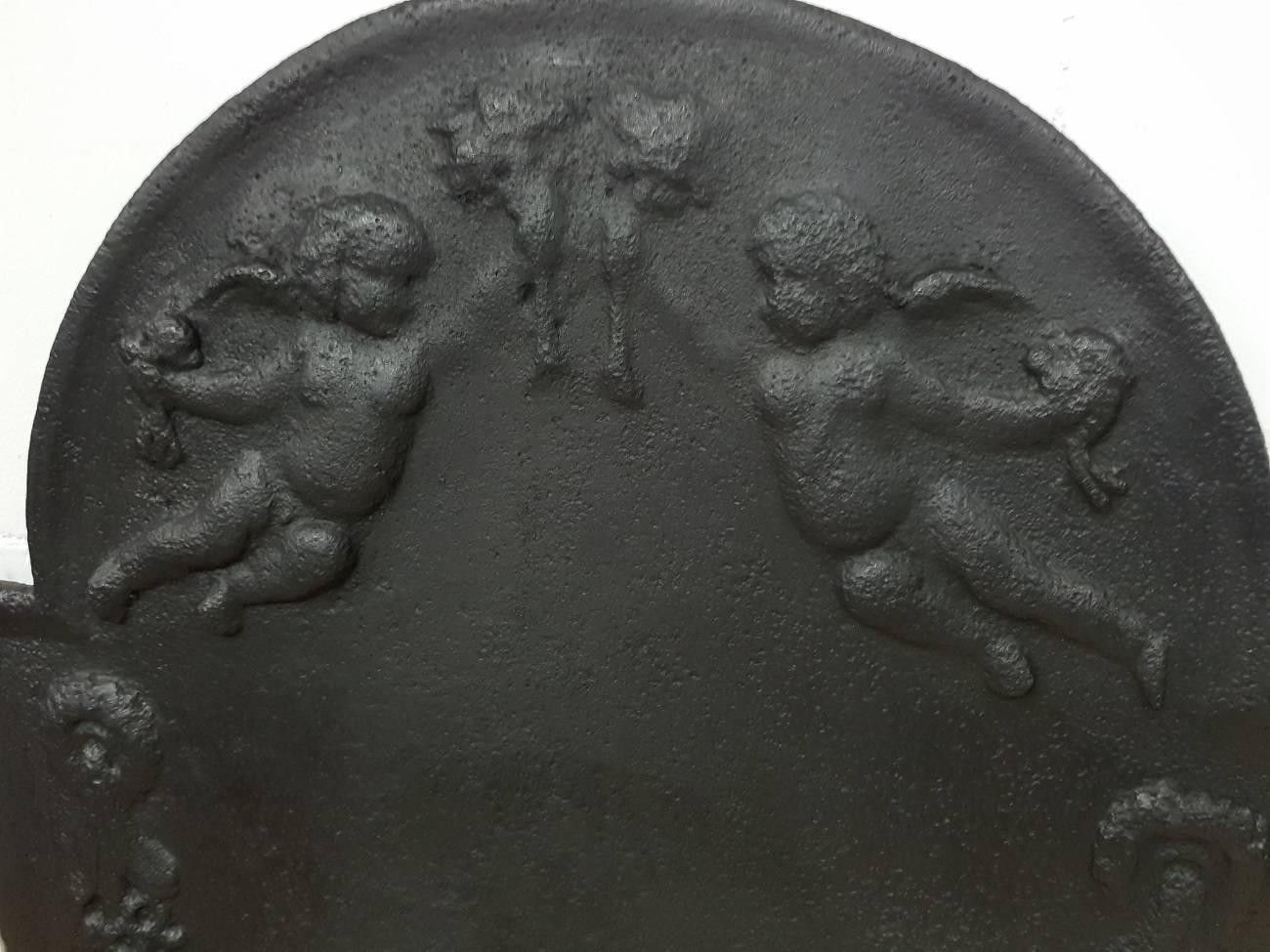19th century Dutch fireplace plate with relief of putti and flowers with fruit, it's made of cast iron and used a lot.

The measurements are,
Depth 1,5 cm/ 0,6 inch.
Width 61 cm/ 24 inch.
Height 78.5 cm/ 30.9 inch.
   