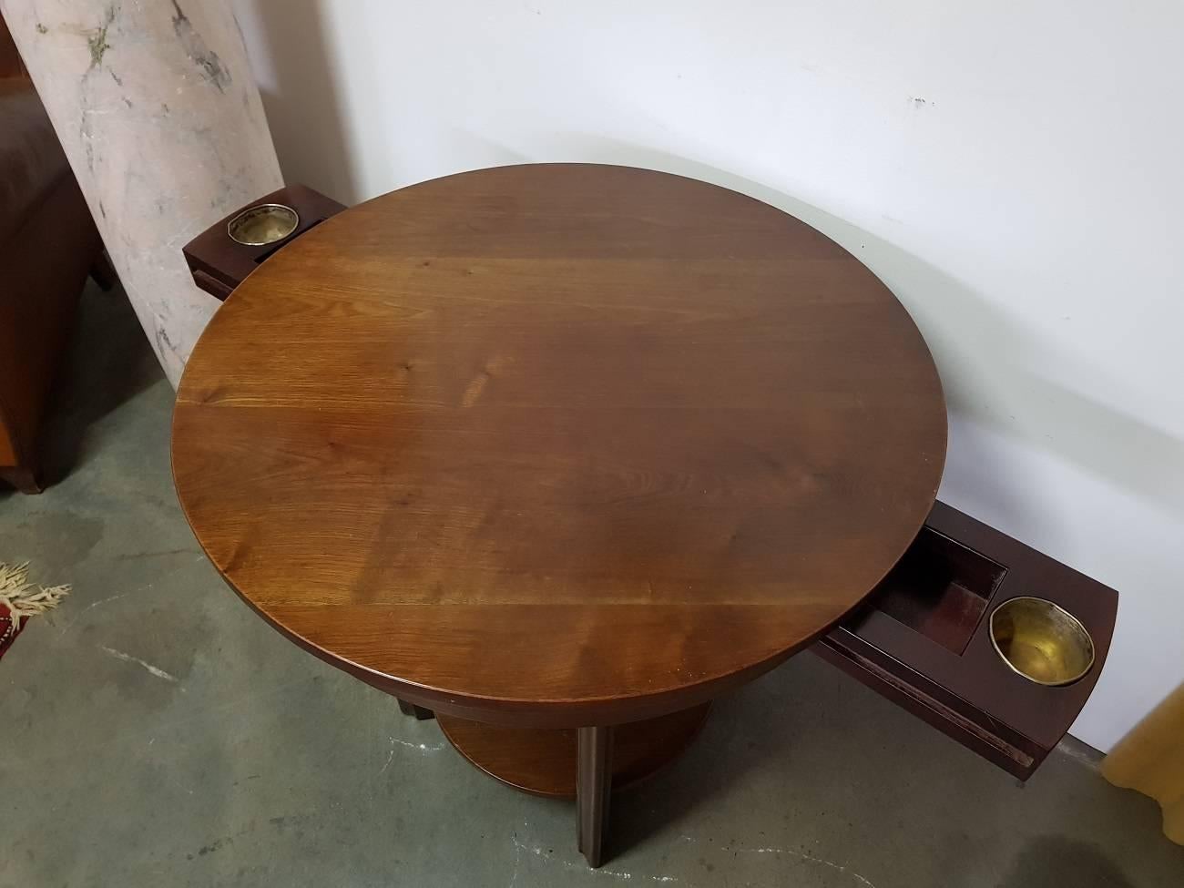 Lovely massive mahogany Art Deco card table from circa 1920 with two drawers in which a worn out silver-plated brass bowl. It is in a good and solid condition with wear consistent by age and use.

The measurements are,
Depth 70 cm/ 27,5