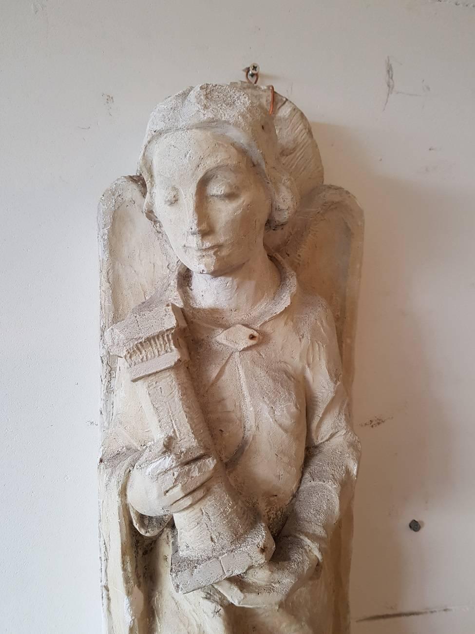 Old plaster wall sculpture depicting an angel holding a pillar and made in the first half of the 20th century and perhaps older.

The measurements are,
Depth 20.5 cm/ 8 inch.
Width 20.5 cm/ 8 inch.
Height 63 cm/ 24.8 inch.
 