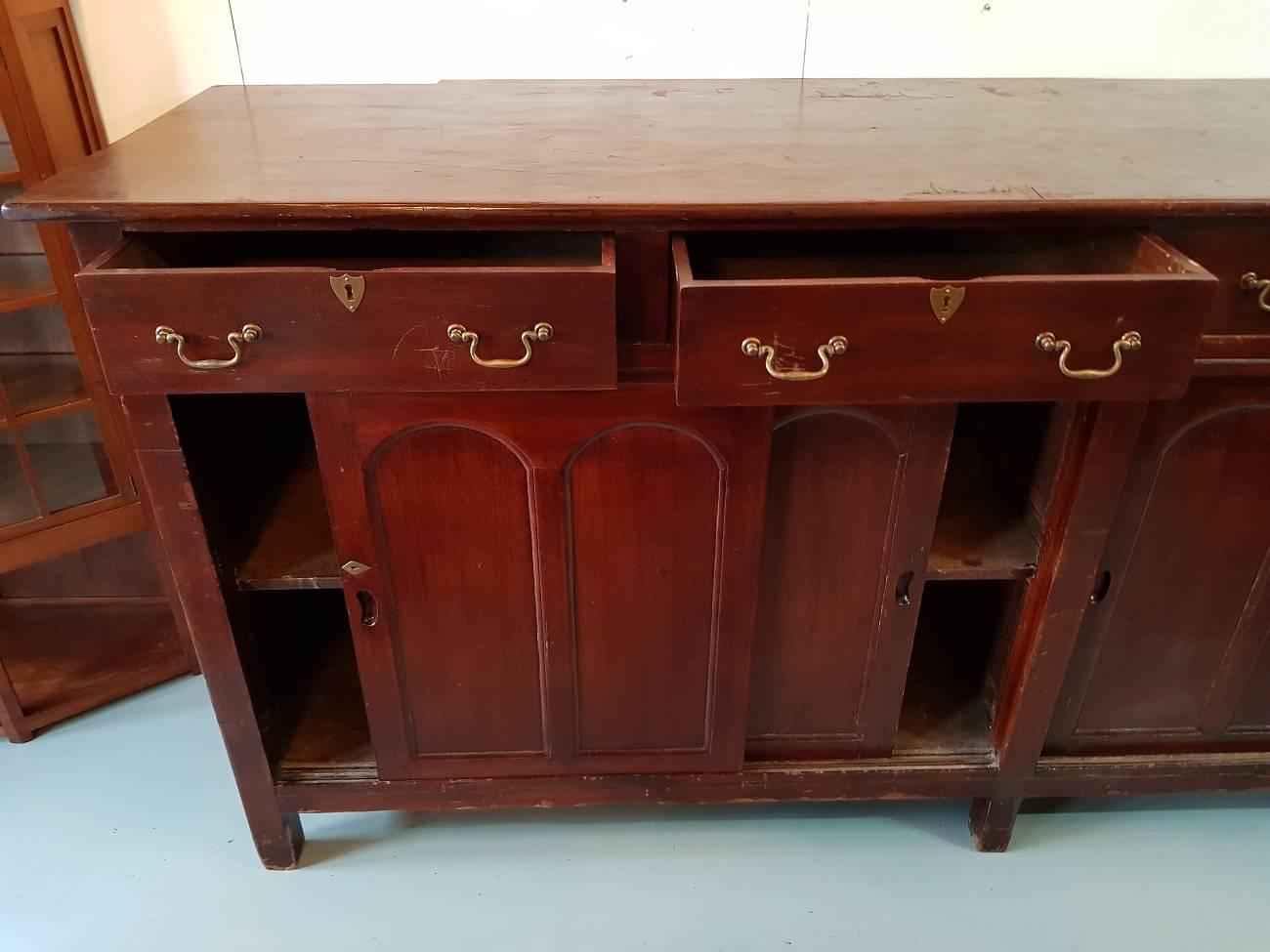 Large English solid Mahogany dresser from the second half of the 19th century with four large drawers and below four sliding doors.

The measurements are,
Depth 75 cm/ 29.5 inch.
Width 275 cm/ 108 inch.
Height 121.5 cm/ 47.8 inch.