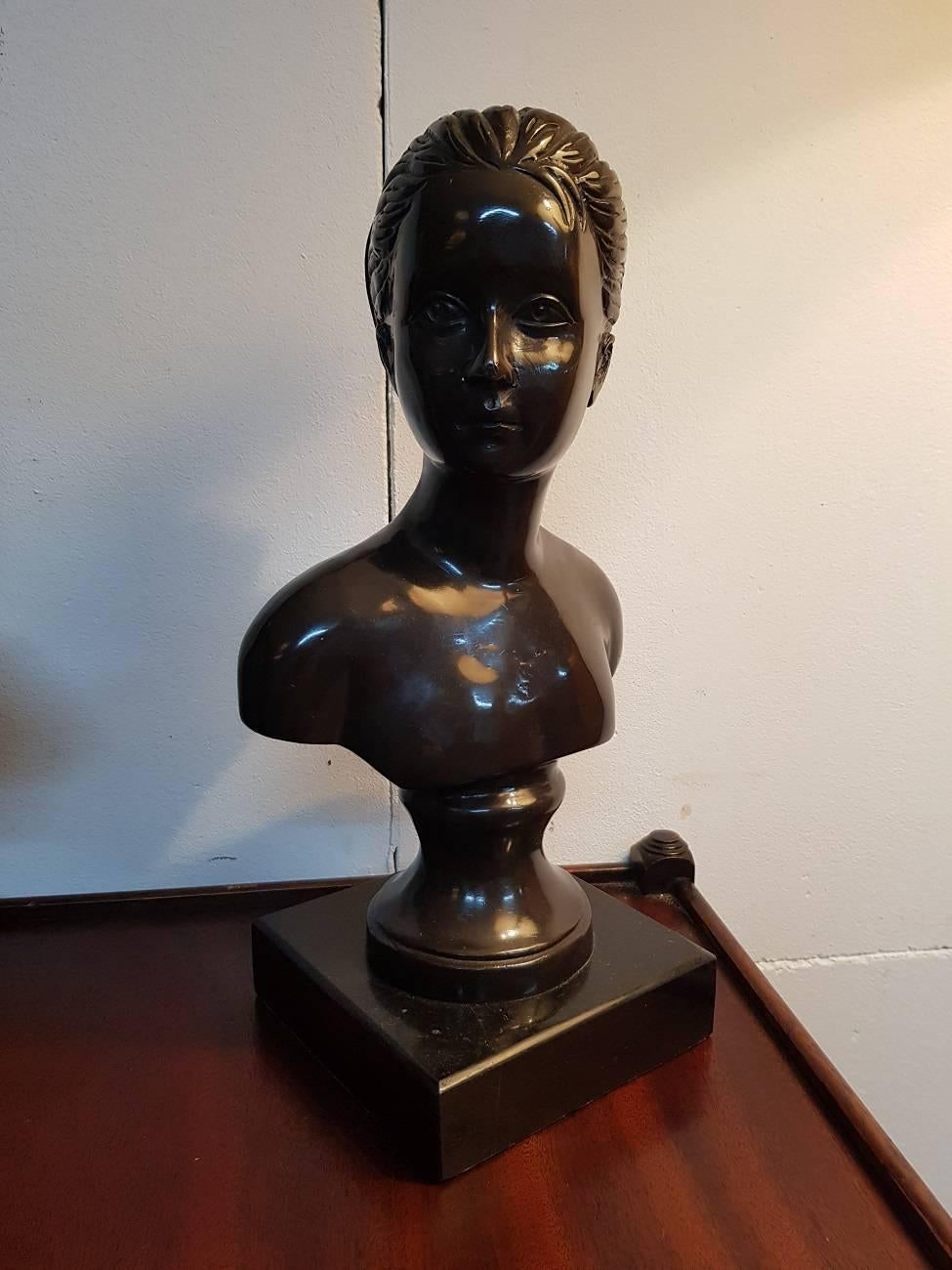 Two bronze busts from the 20th century on a black marble base representing a boy and girl.

The measurements are,
Depth 14 cm/ 5.5 inch.
Width 18 cm/ 7 inch.
Height 36 cm/ 14.1 inch.
 