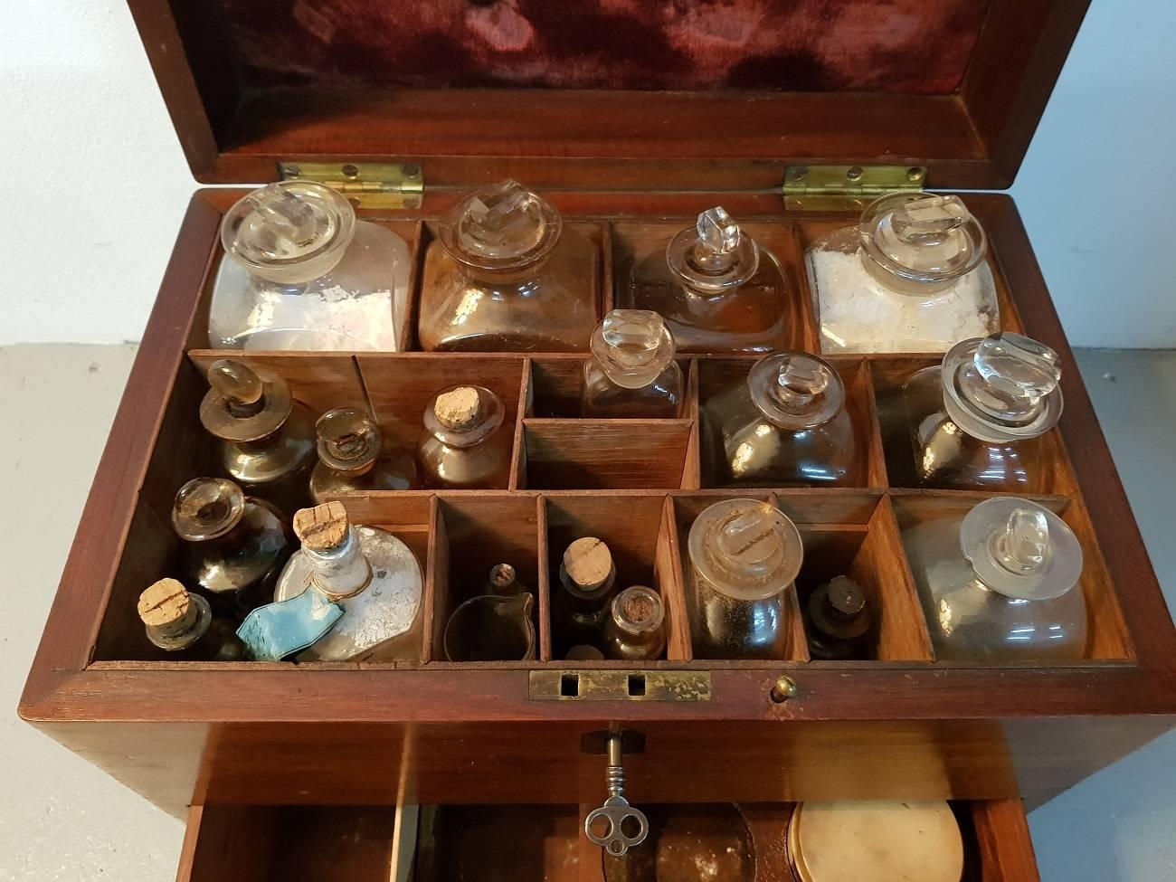Antique late 19th century English mahogany doctors or apothecary travel box or cabinet with various bottles and attributes including mortar with pestle old heat plaster with beautiful illustrations etc.

The measurements are,
Depth 23.5 cm/ 9.2