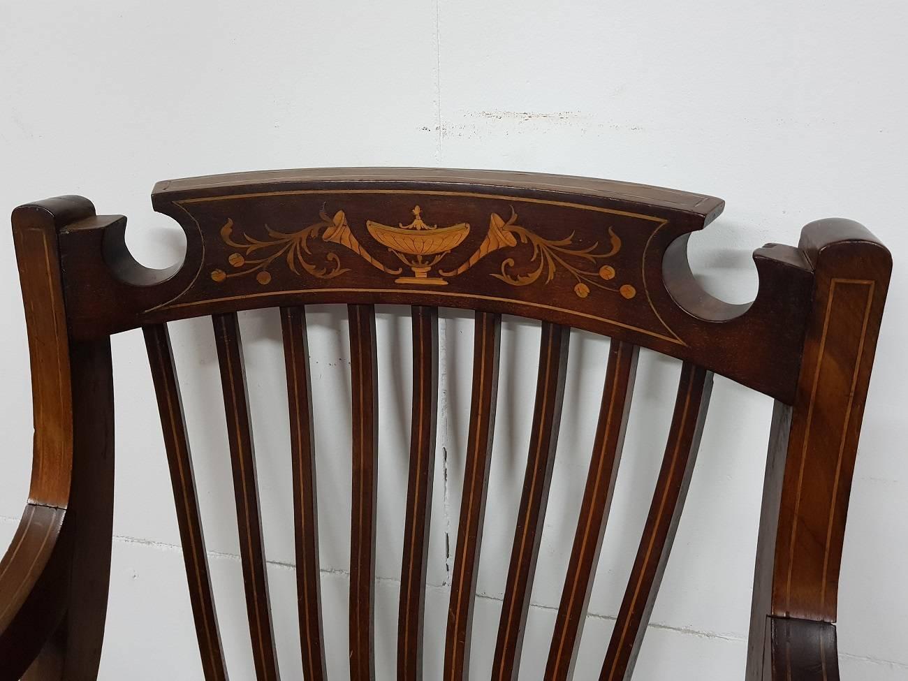 English mahogany Regency style armchair inlaid with various types of wood and made in the second half of the 19th century.

The measurements are.
Depth 60 cm/ 23.6 inch.
Width 59 cm/ 23.2 inch.
Height 93 cm/ 36.6 inch.
Seat height 46 cm/ 18.1