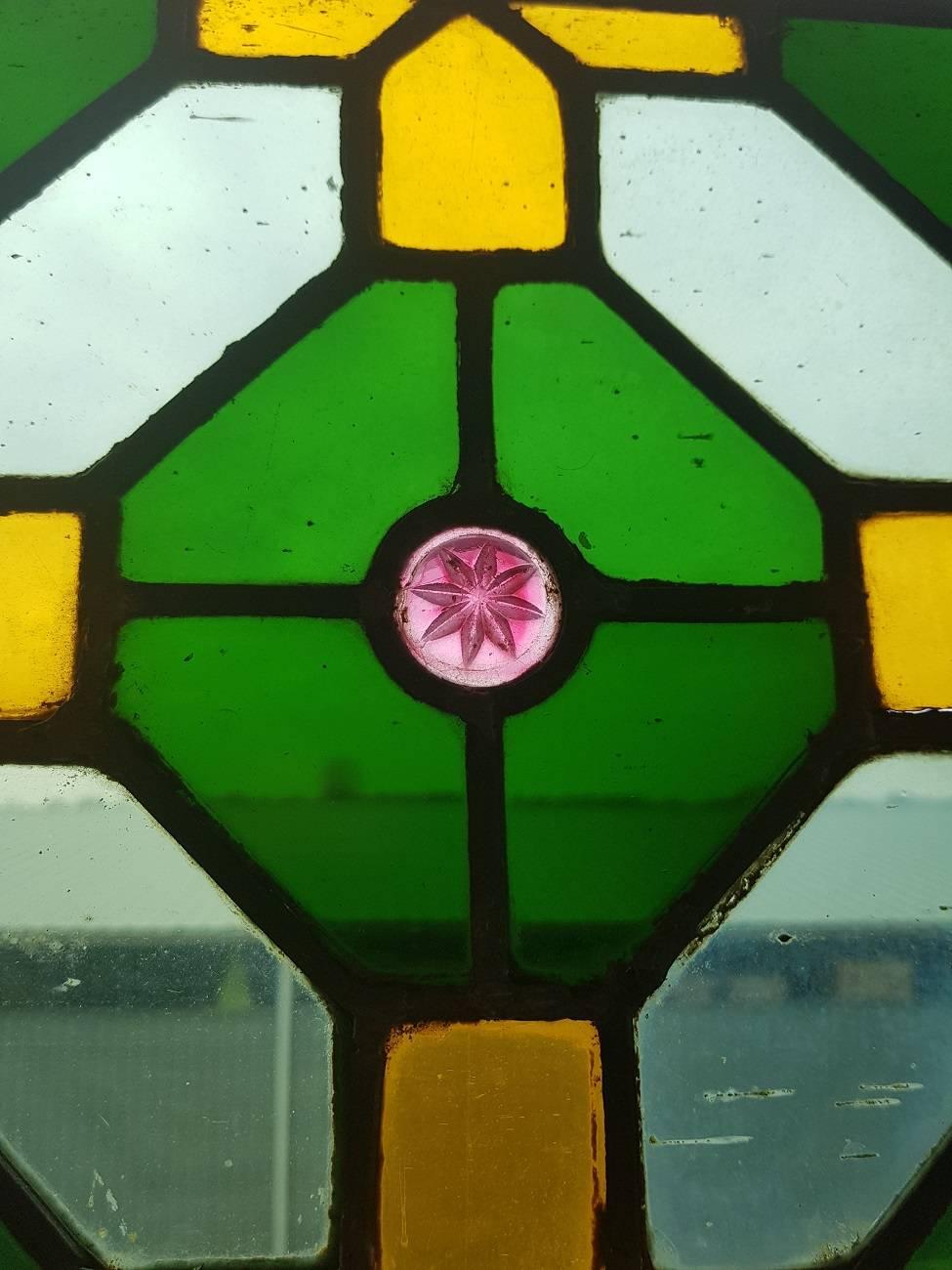 Late 19th century stained glass window from a religious building with beautiful colors and red stars, the outer edge is of a later date and has some cracks but still a wonderful decorative object.

The measurements are,
Depth 0.5 cm/ 0.19