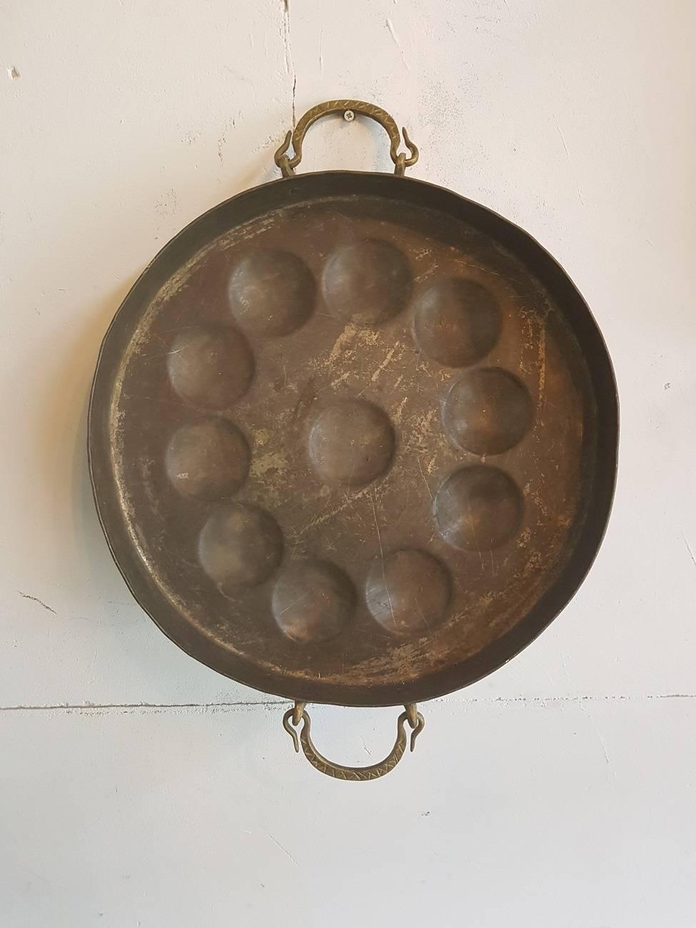 Large Dutch copper mini pancakes pan with brass handles from the first half of the 20th century.

The measurements are:
Depth 6 cm/ 2.3 inch.
Width 40 cm/ 15.7 inch.
Height 40 cm/ 15.7 inch.
 