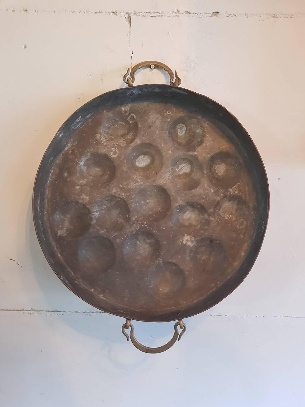 Beautiful Large Old Dutch copper mini pancake pan with the initials B E A and the year 1938 stamped on the side. Very decorative in a rural kitchen interior.

The measurements are,
Depth 7 cm/ 2.7 inch.
Width 45 cm/ 17.7 inch.
Height 45 cm/