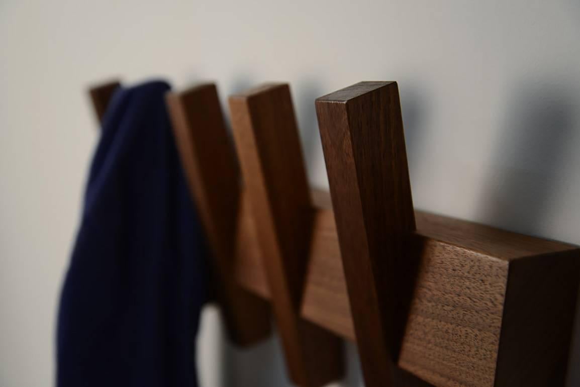 The Enos coat rack is built by hand in our Brooklyn studio using premium hardwoods. Our interpretation of the iconic Shaker peg rail, features simple forms and some less than simple geometry. Attaches to the wall using a hidden cleat system